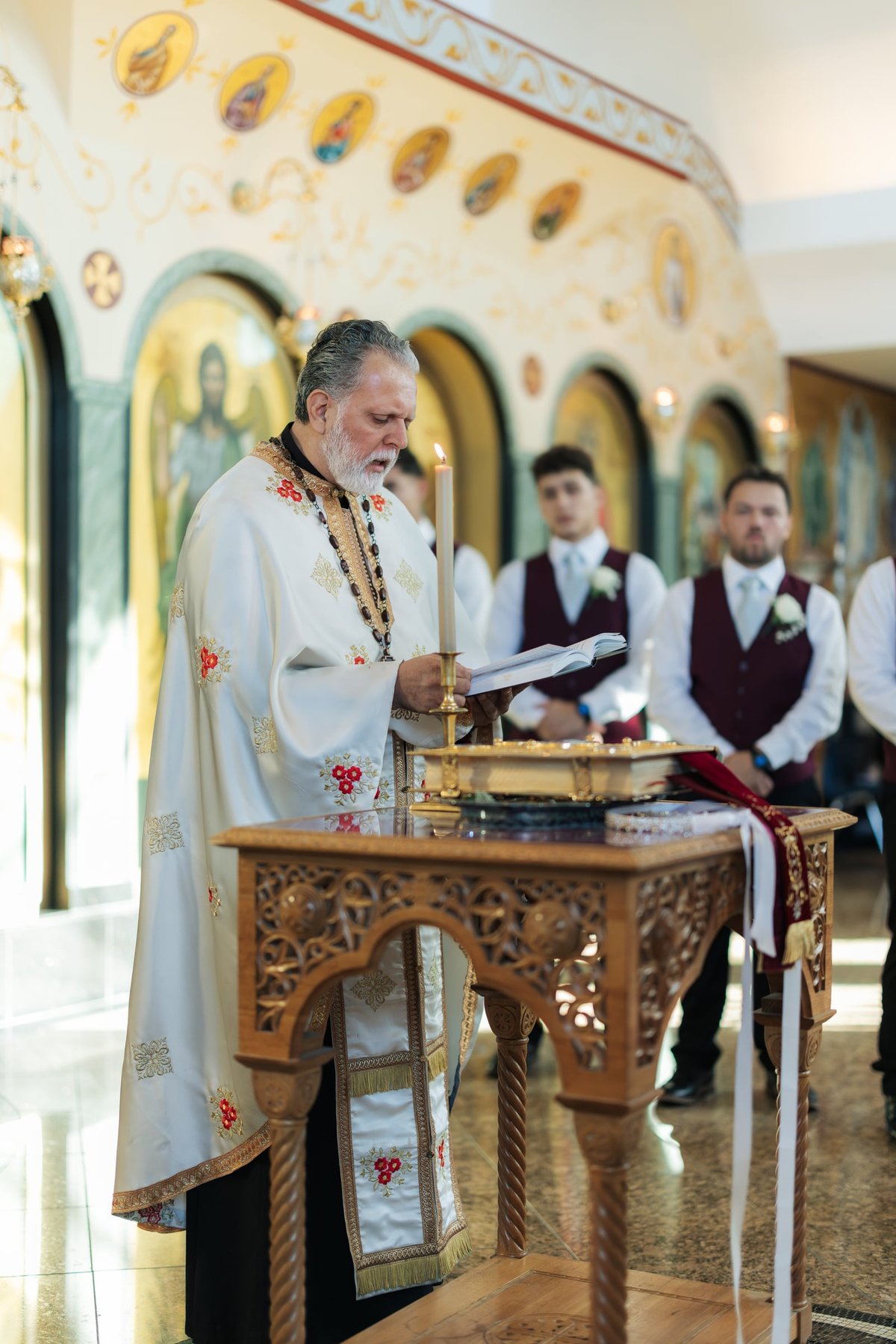 The priest reads at the center of the church during an Orthodox wedding service