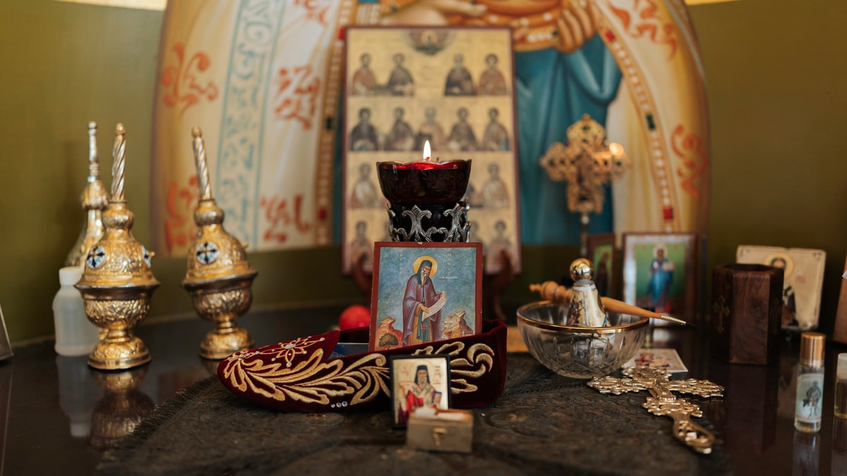 Candles, crowns, and icons prepared inside an Orthodox church