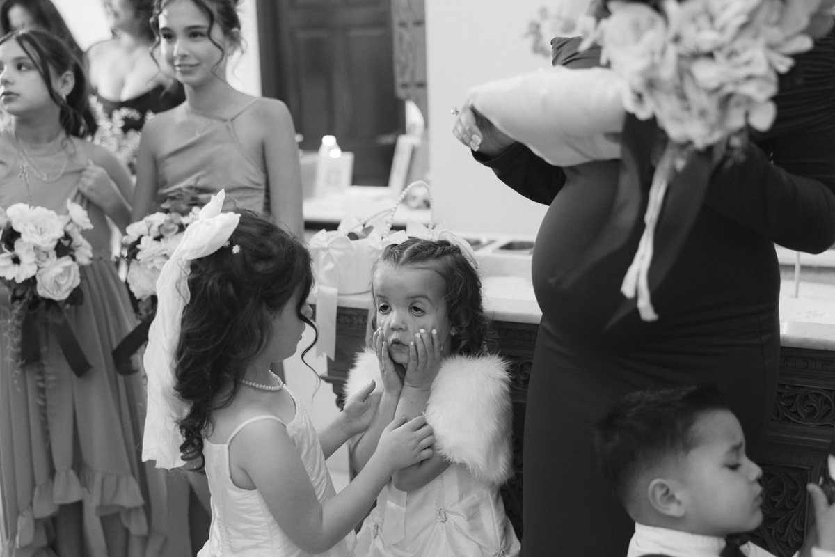 A flower girl reacts as the wedding party gathers inside the church