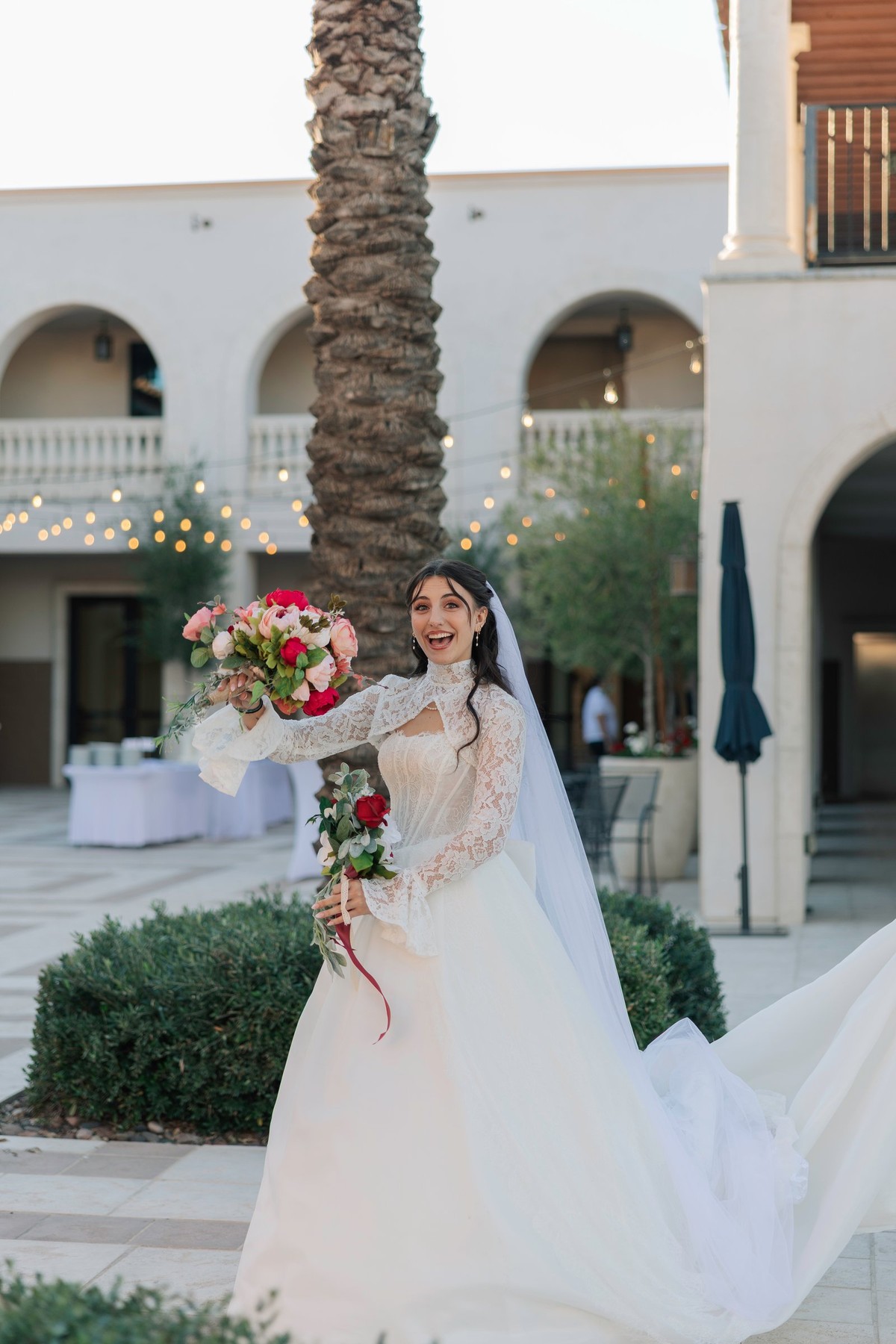 The bride holds her bouquet outside an Orthodox church
