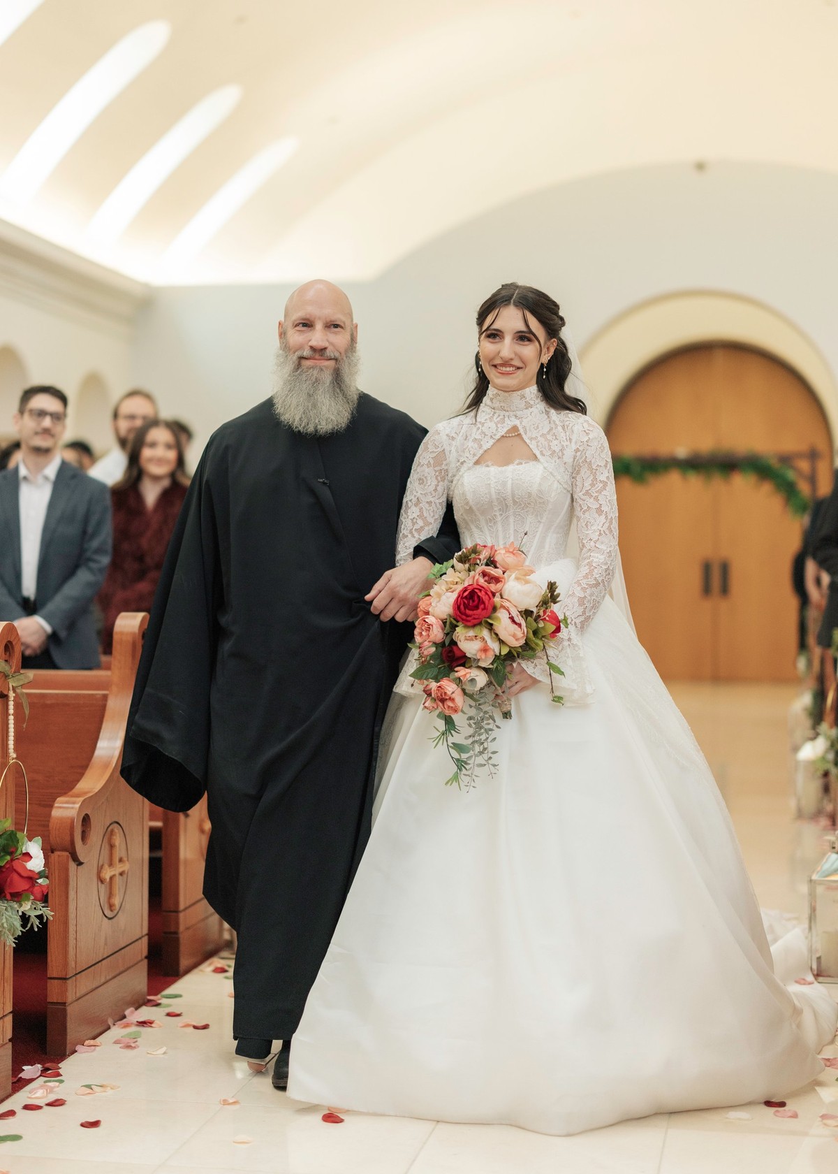 An Orthodox priest escorts the bride toward the front of the church