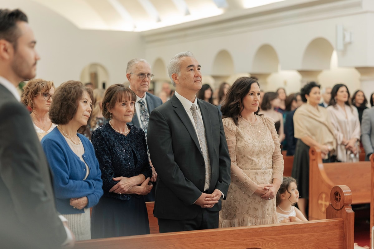 Guests watch the ceremony from a church pew