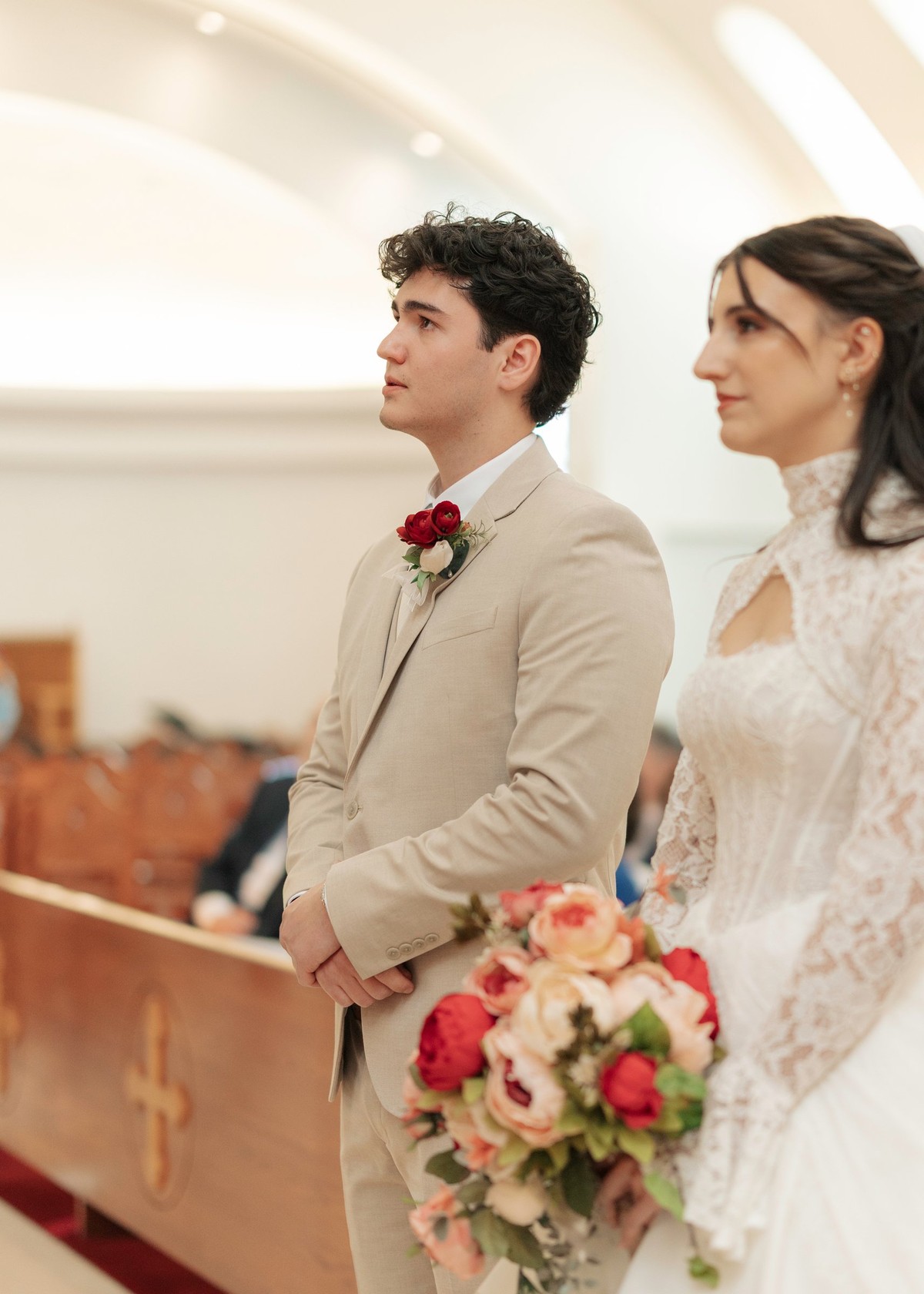 The bride and groom stand together at the start of the service
