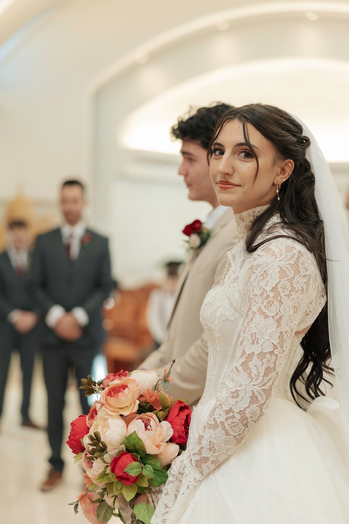The bride holds her bouquet during the wedding service