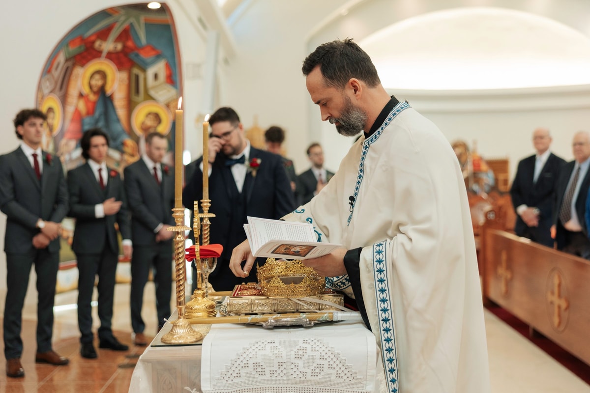 An Orthodox priest begins the wedding service before the bride and groom