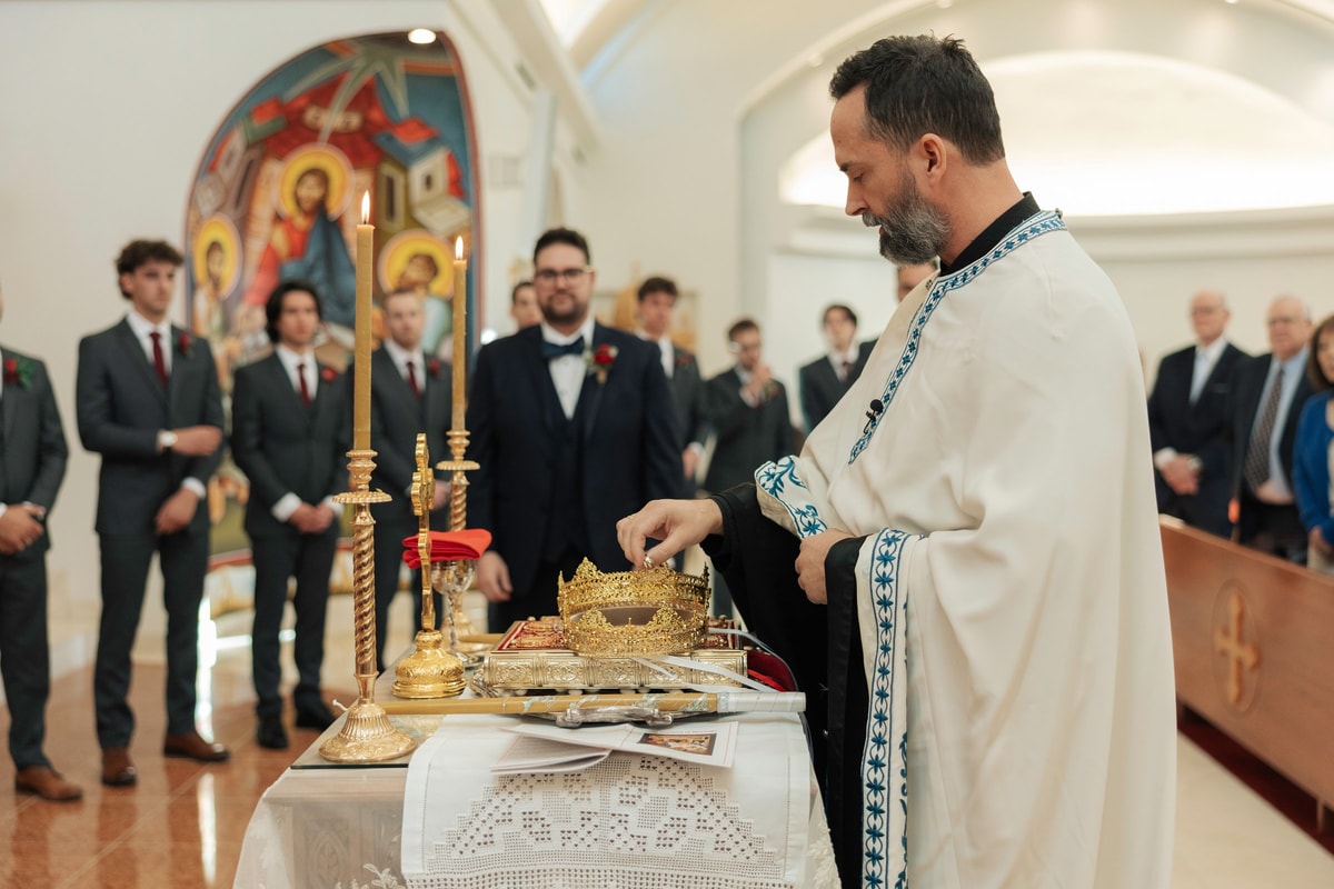 An Orthodox priest begins the wedding service before the bride and groom