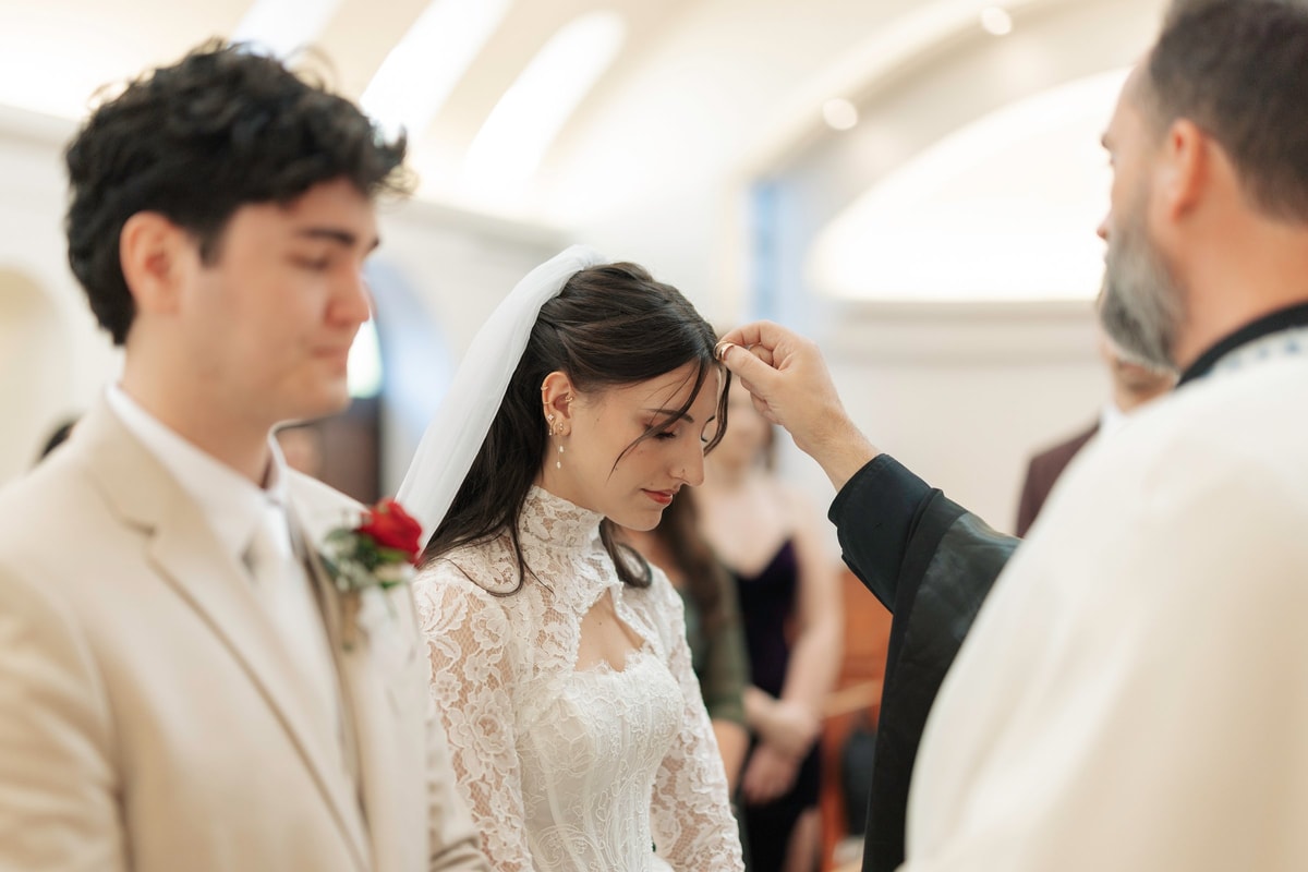 An Orthodox priest blesses the bride during the wedding service