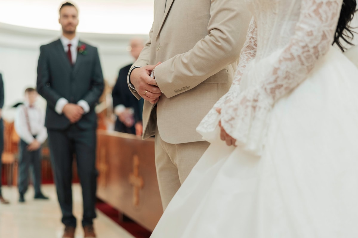 The bride and groom hold hands during the ceremony