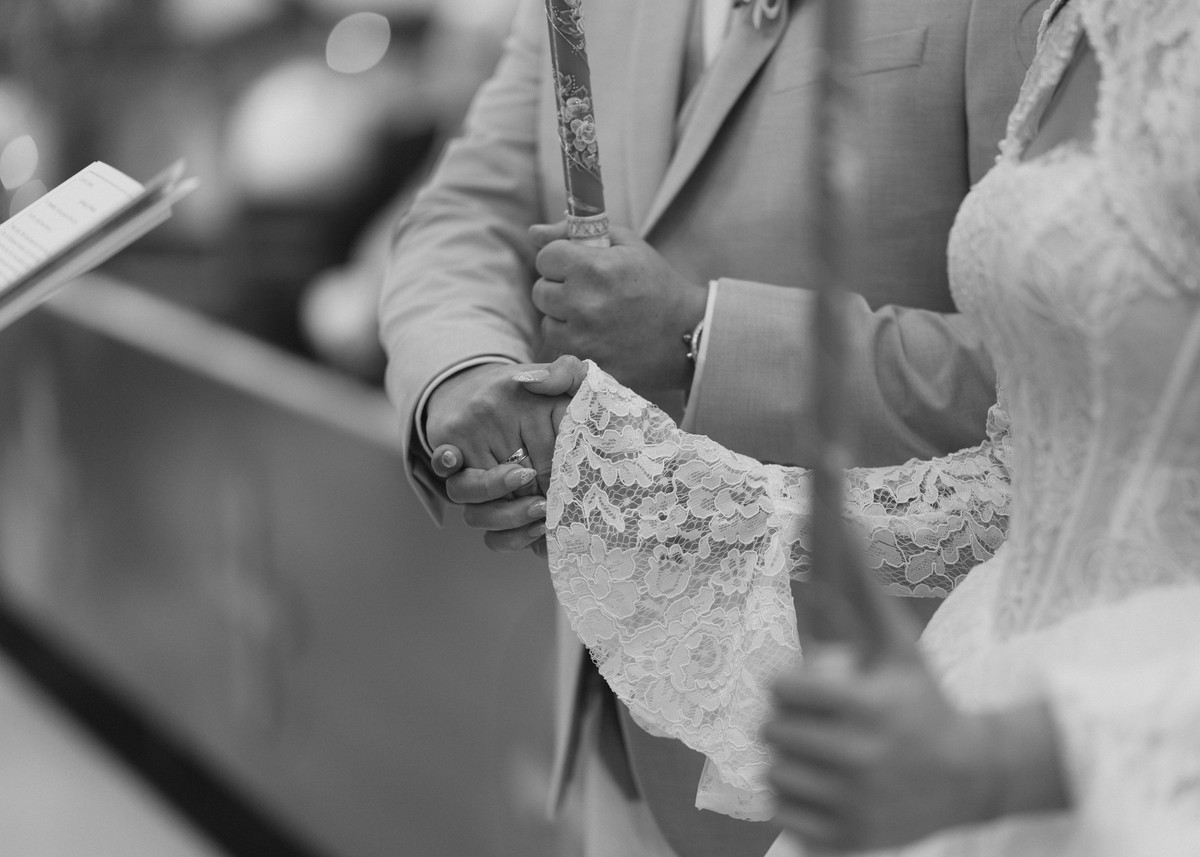 The priest joins the couple's hands during the service