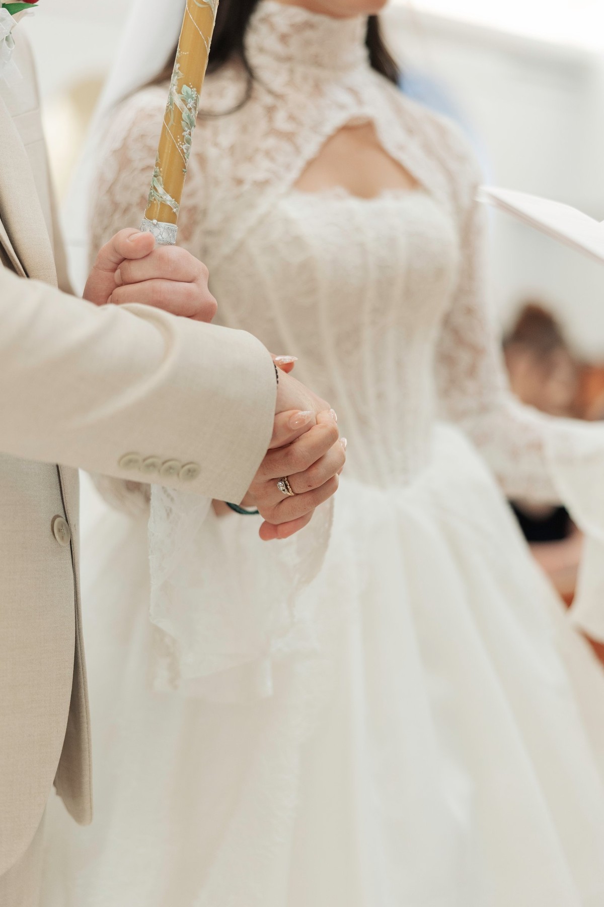 The priest joins the couple's hands during the service