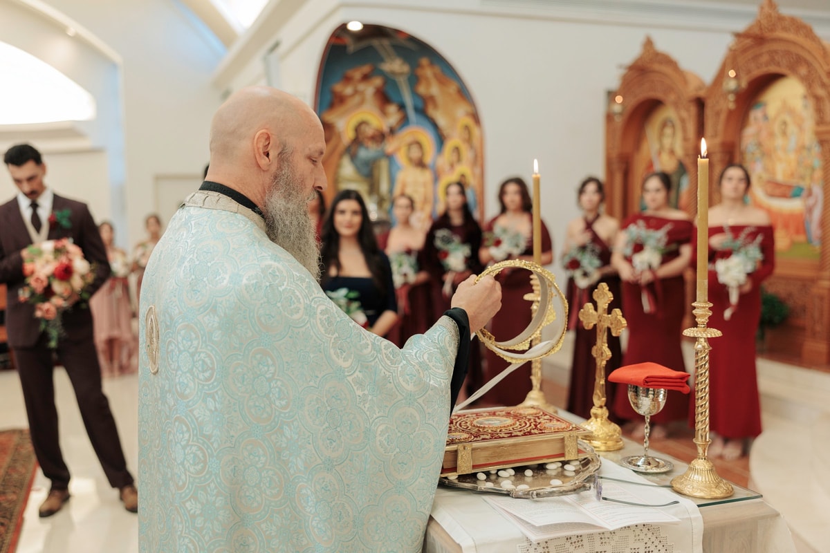 A priest reads before the bride and groom at the tetrapod