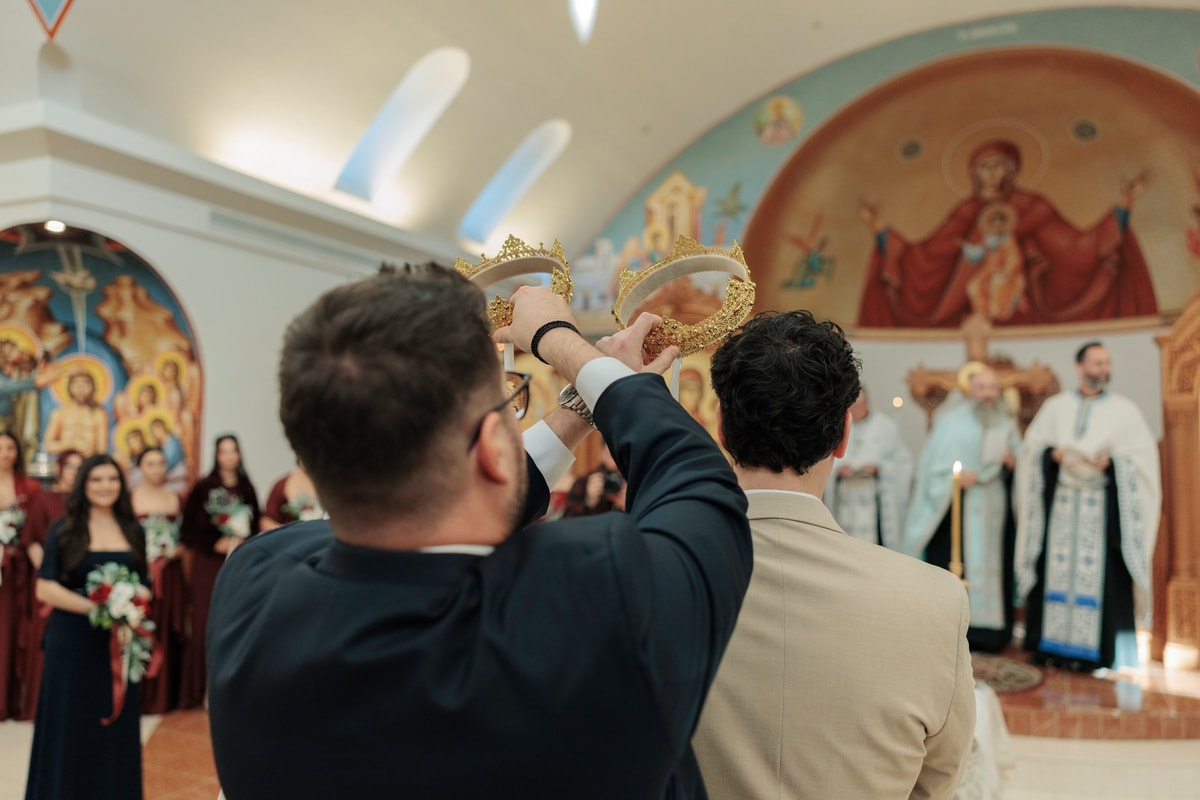 A guest photographs the bride and groom during the Crowning