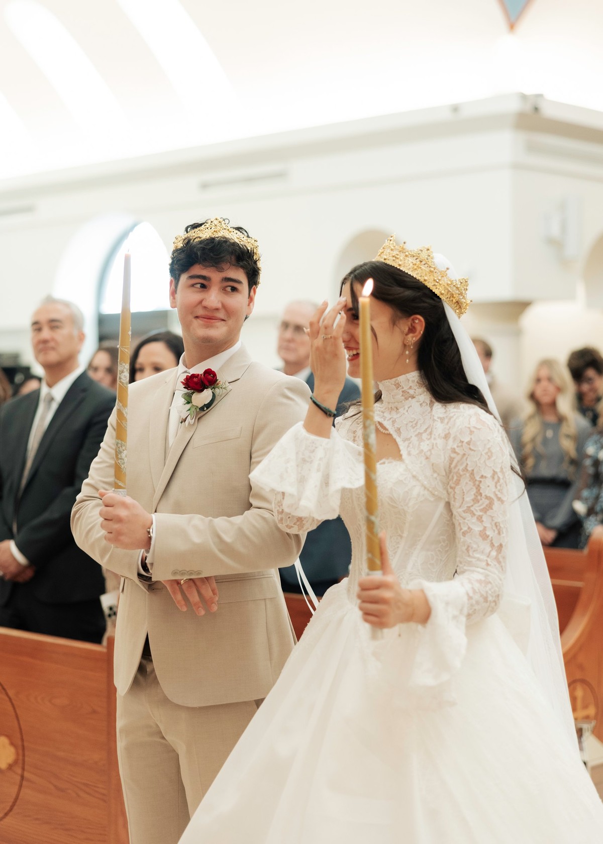 The bride and groom follow the priest during the procession