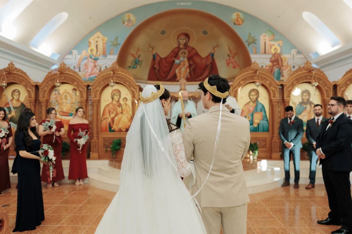 The groom receives the common cup from the priest