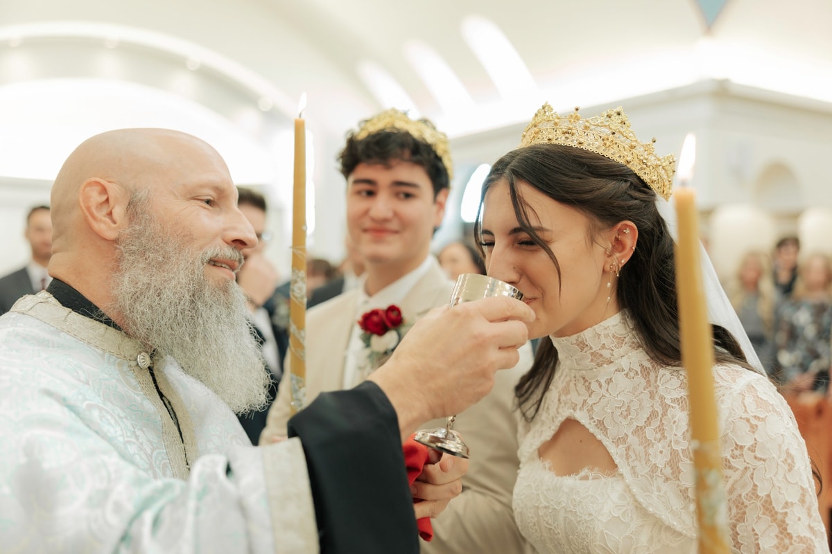 The bride drinks from the common cup