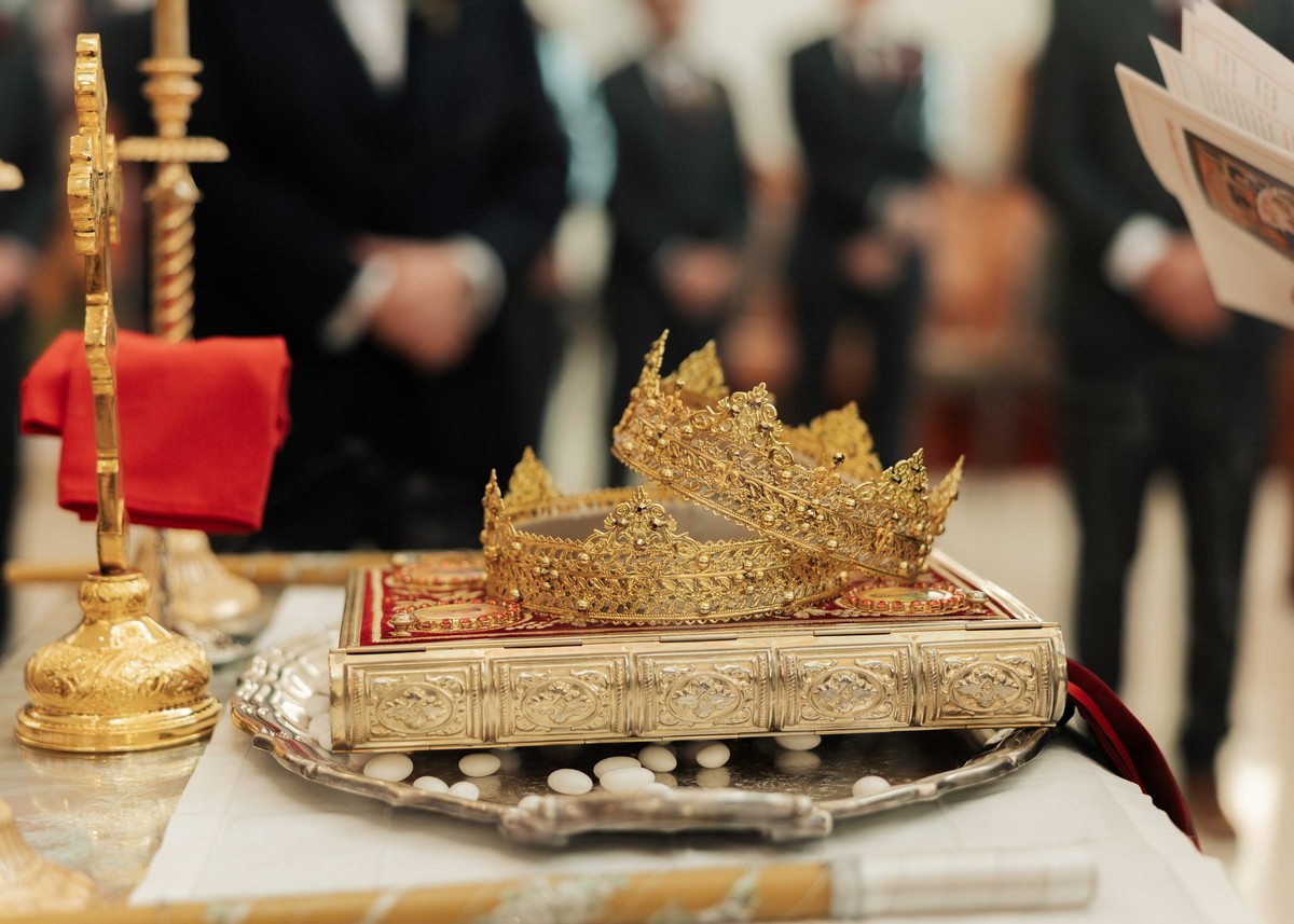 The wedding crowns rest on the Gospel book after the ceremony