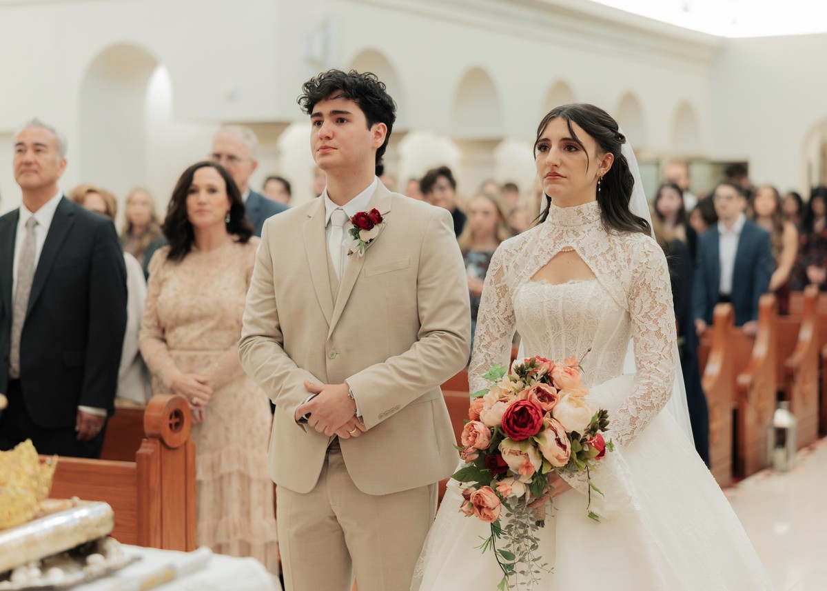 The bride and groom stand together at the close of the service
