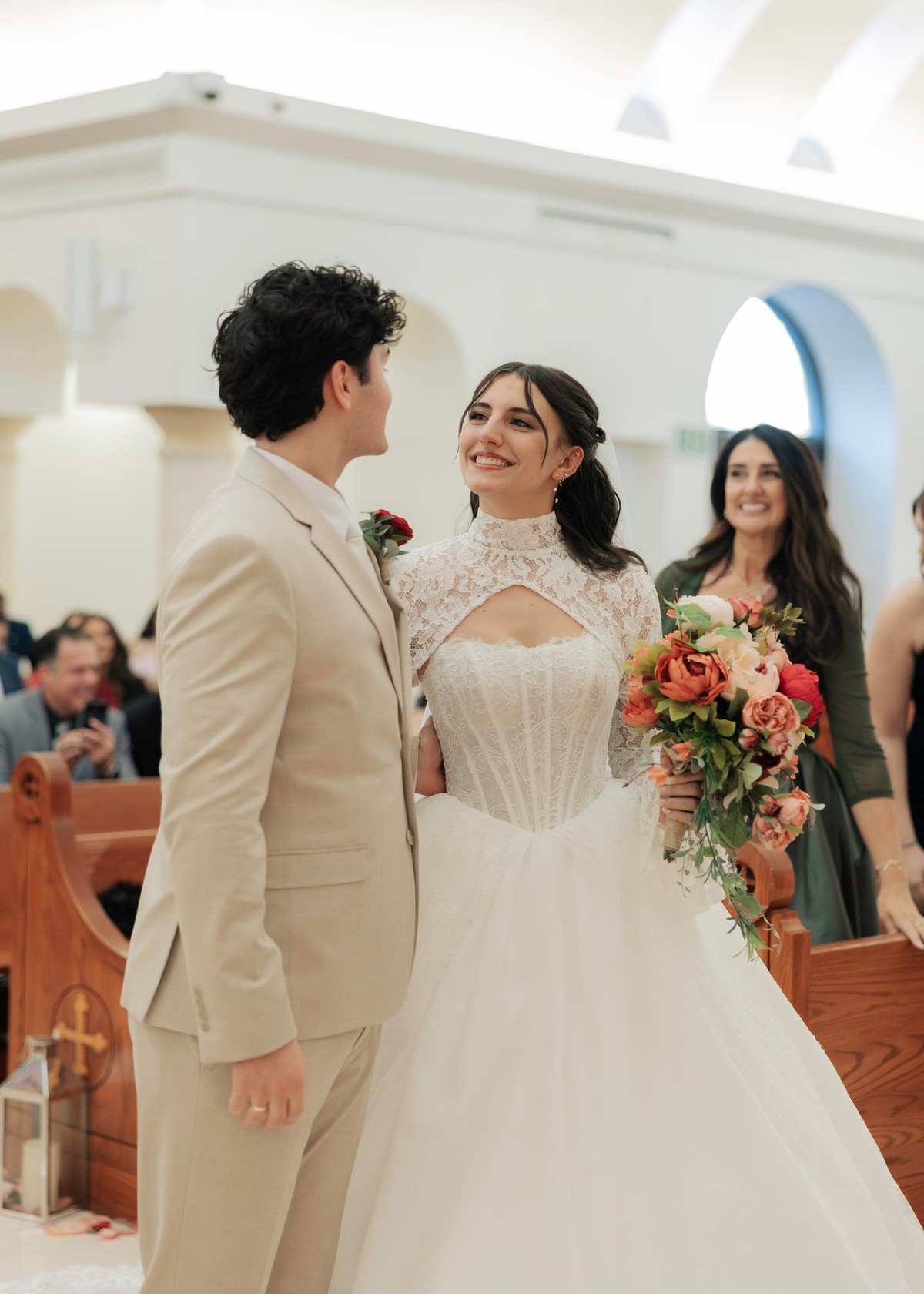 The bride and groom smile at one another after the ceremony