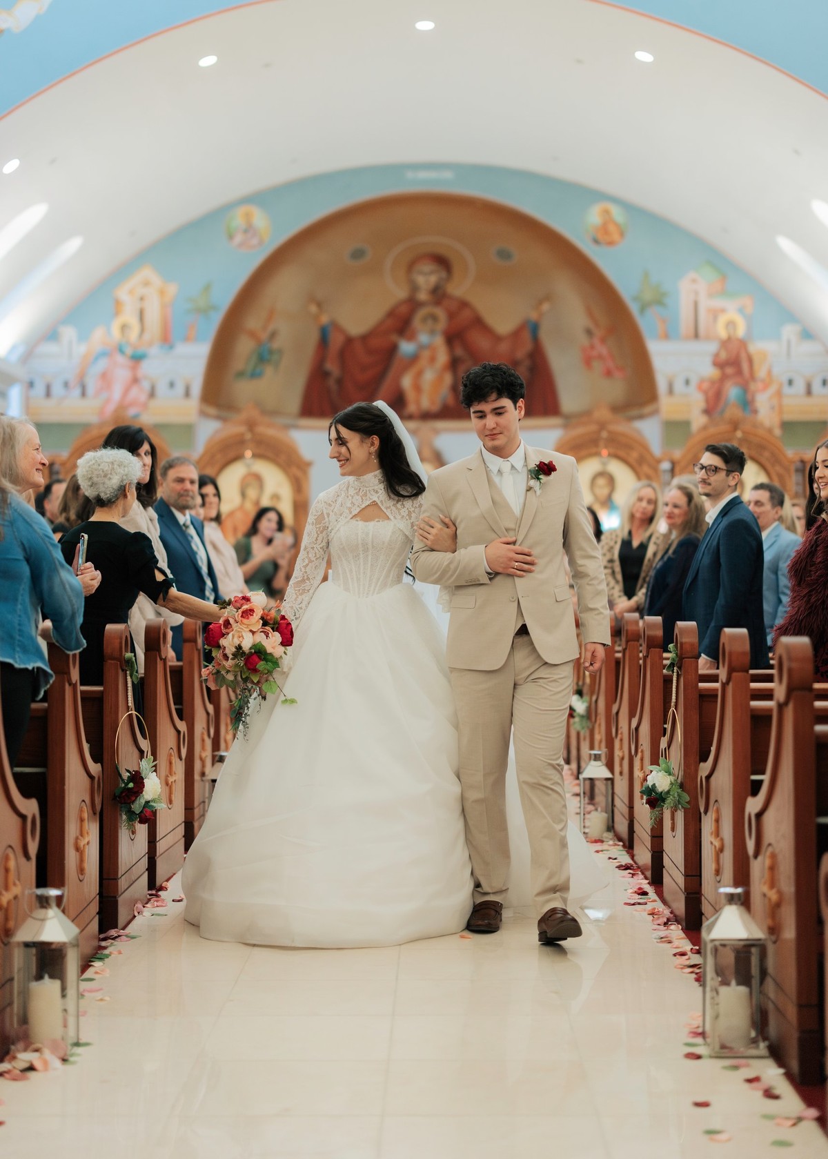 The newly married couple walks back down the church aisle