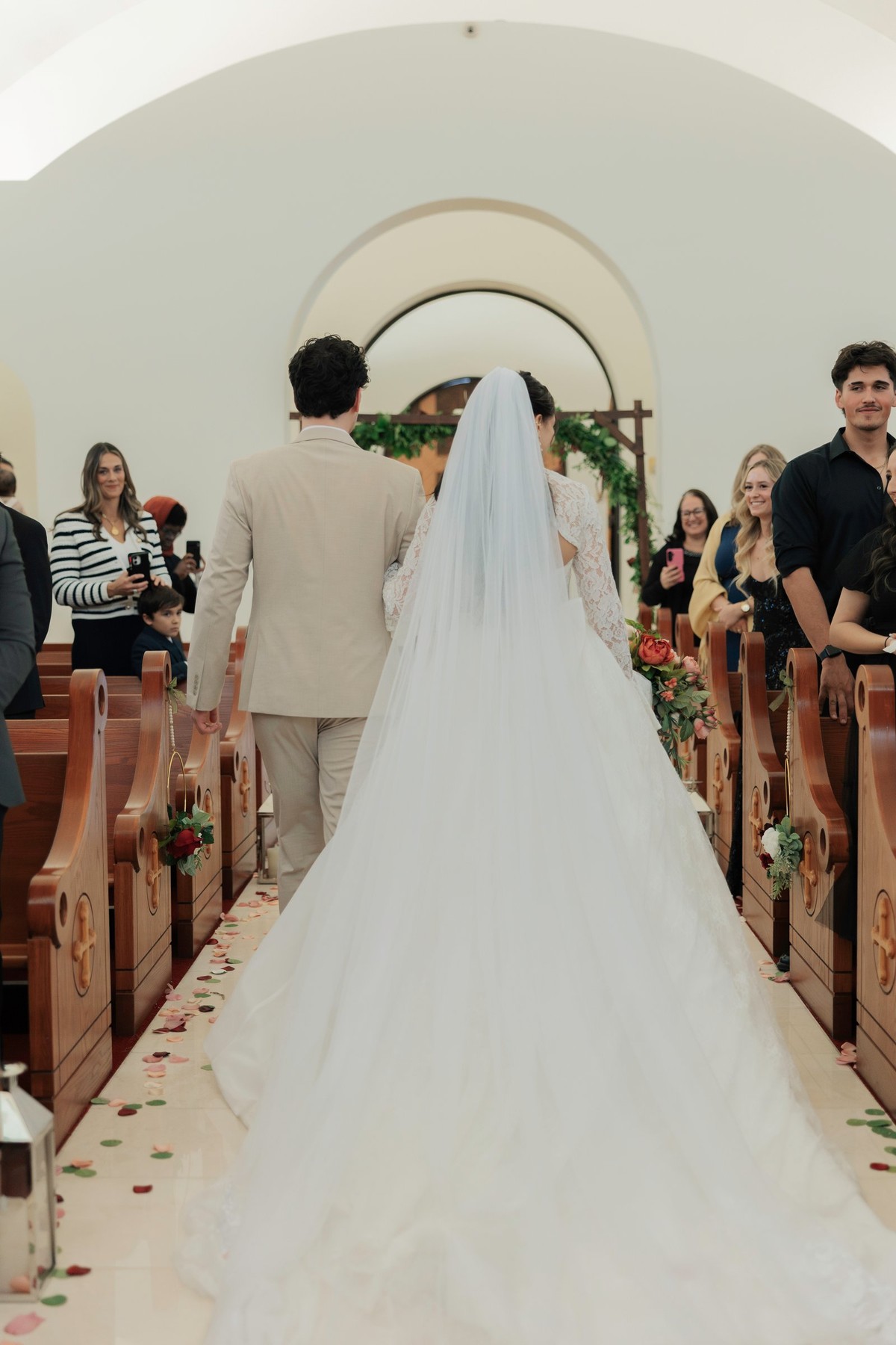 The newly married couple walks back down the church aisle