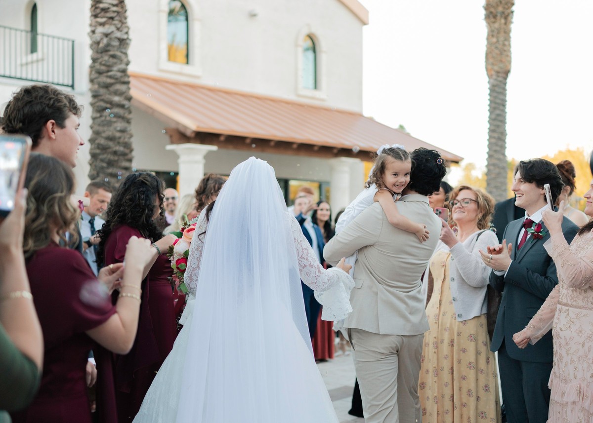 Guests congratulate the bride outside the church