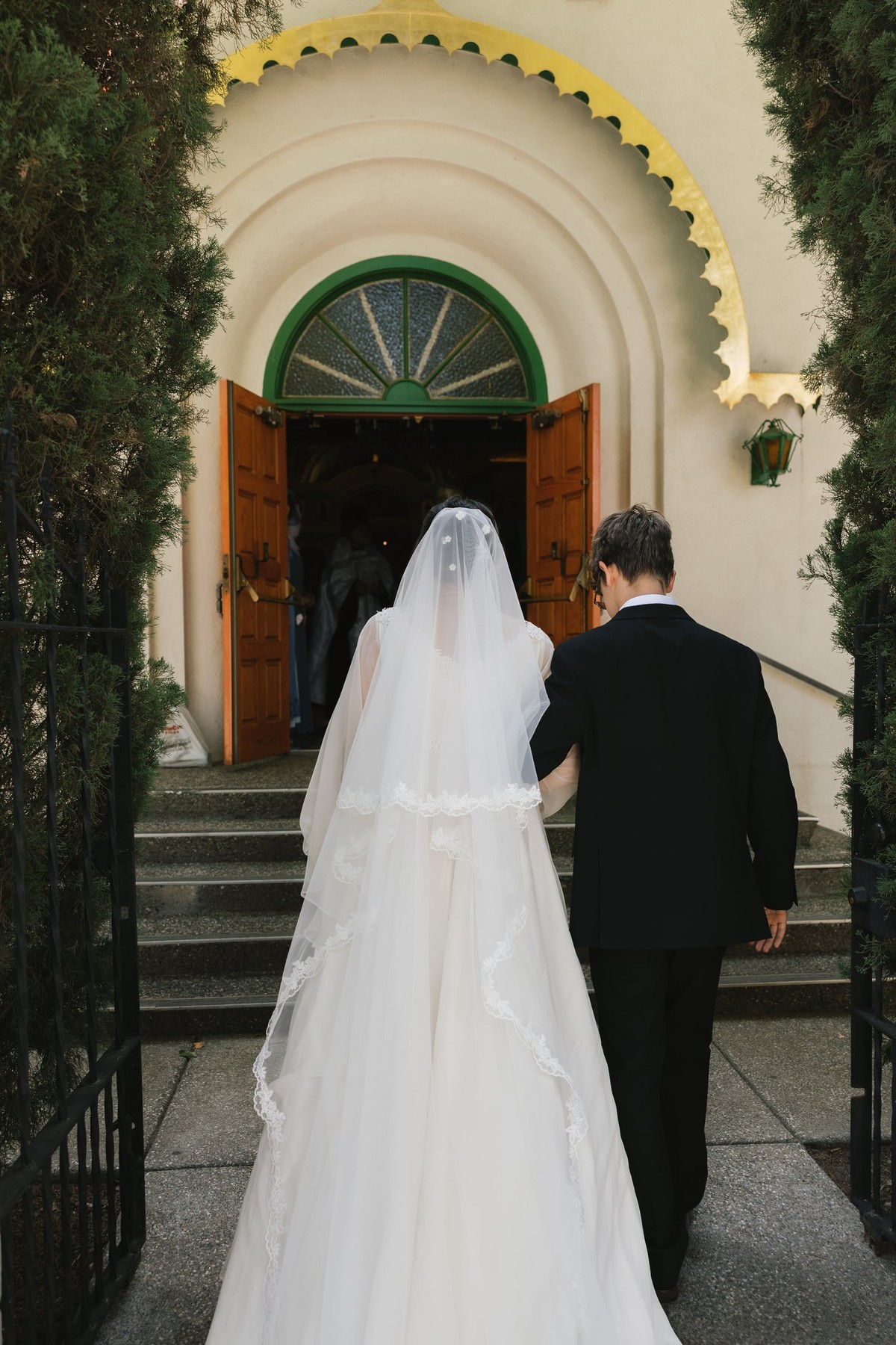 The bride and groom enter the church together
