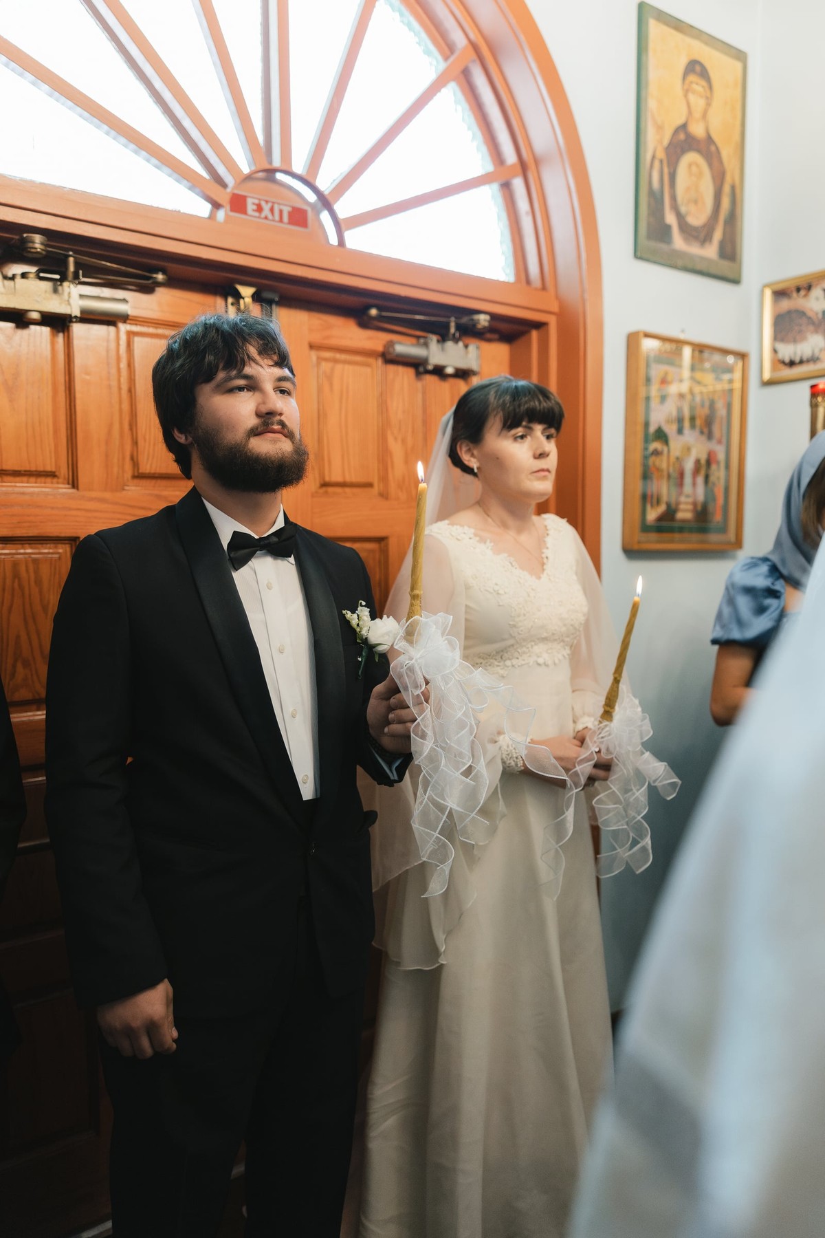 The bride and groom stand together during the wedding service