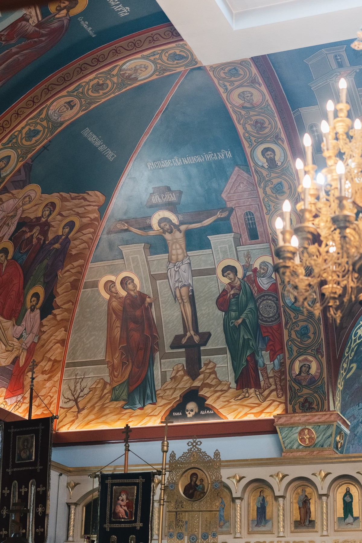Painted saints and biblical scenes above an Orthodox iconostasis