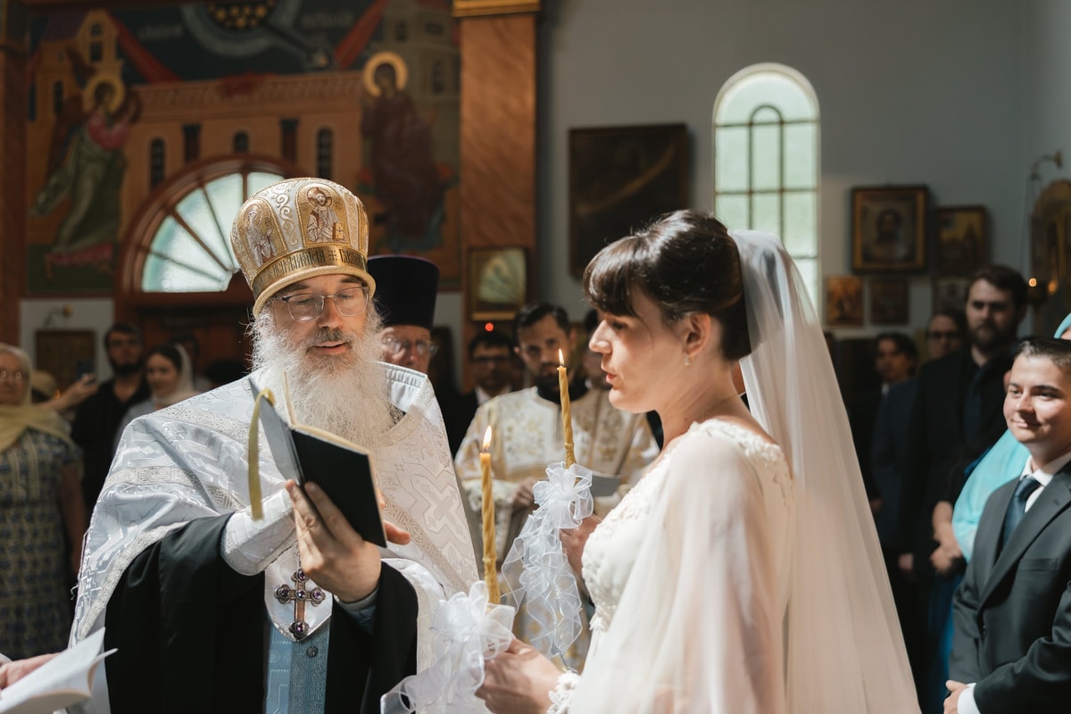 The bride listens as the bishop reads the marriage prayers