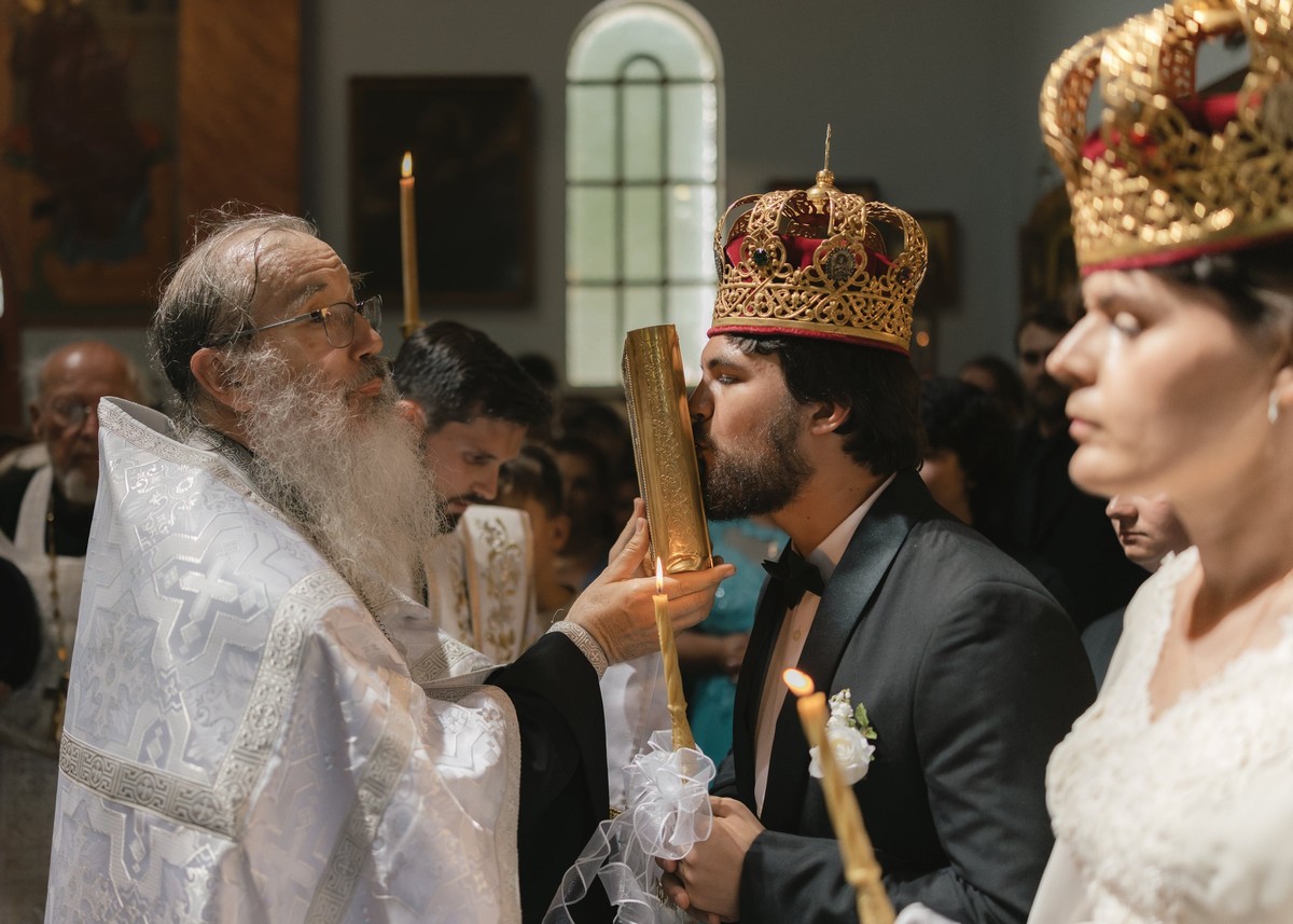 The bishop serves the crowned couple during the marriage rite