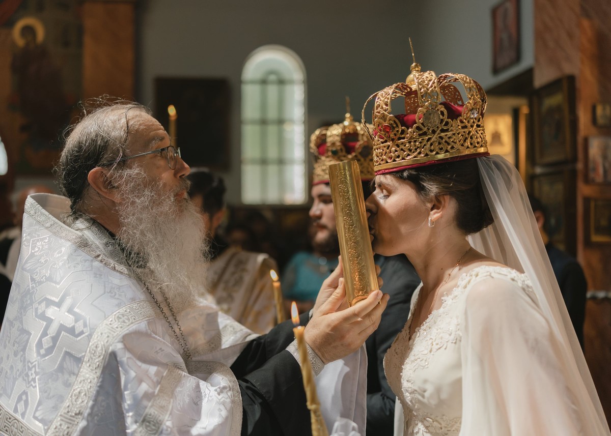 The bishop serves the crowned couple during the marriage rite