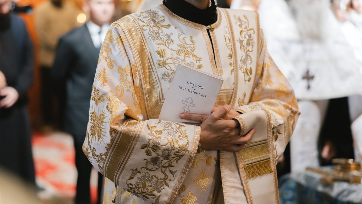 A deacon reads during the wedding service