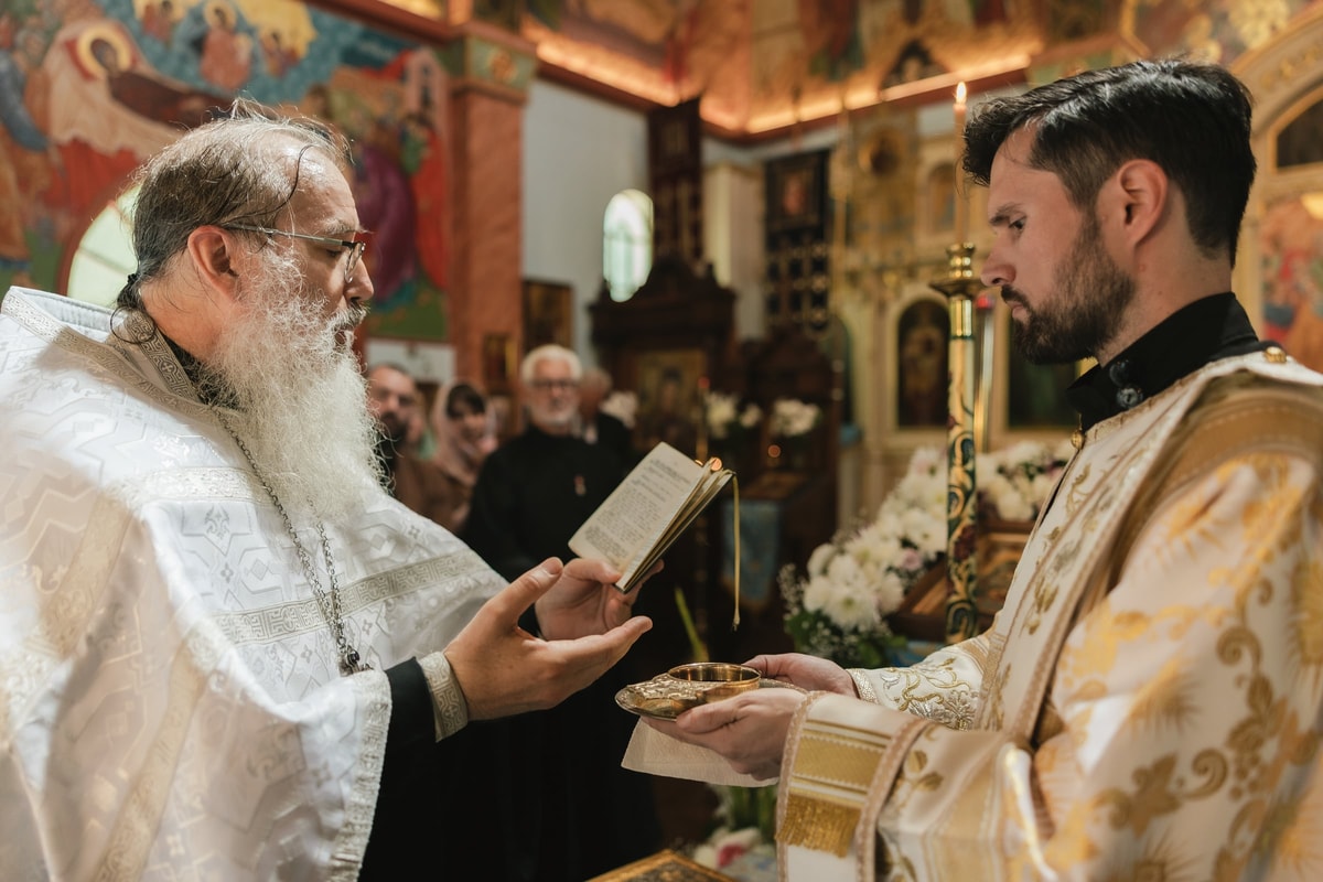 The bishop reads prayers over the common cup