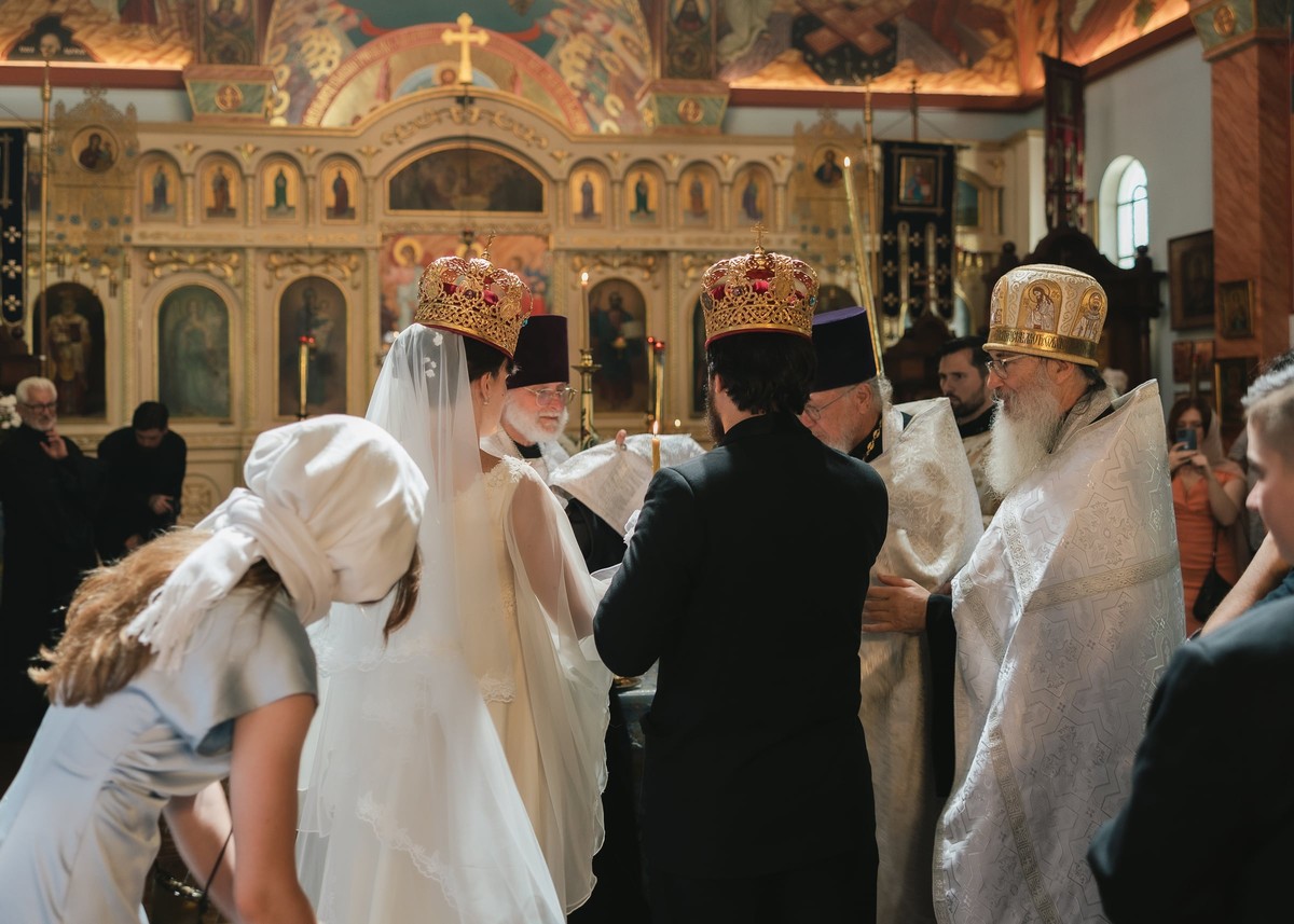 The bride bows to receive a blessing during the service