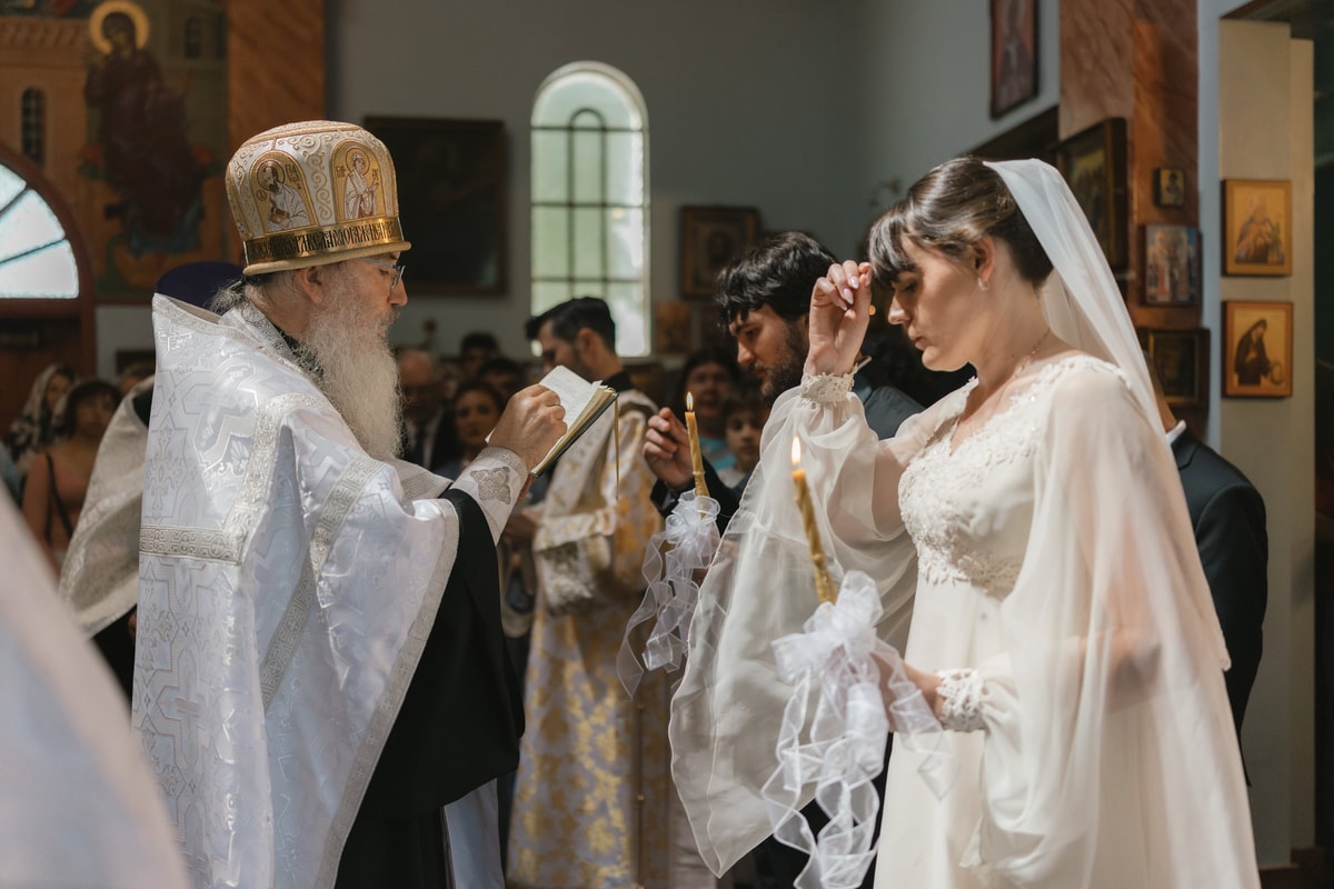 The bride makes the sign of the cross