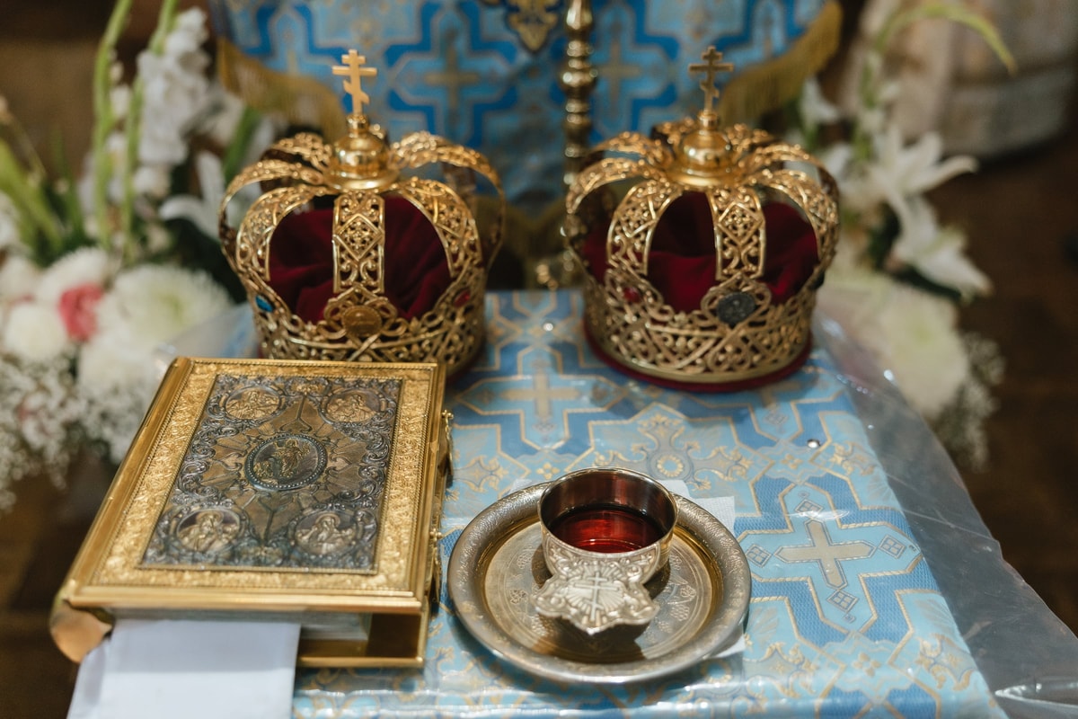 Wedding crowns, the Gospel book, and common cup on the service table