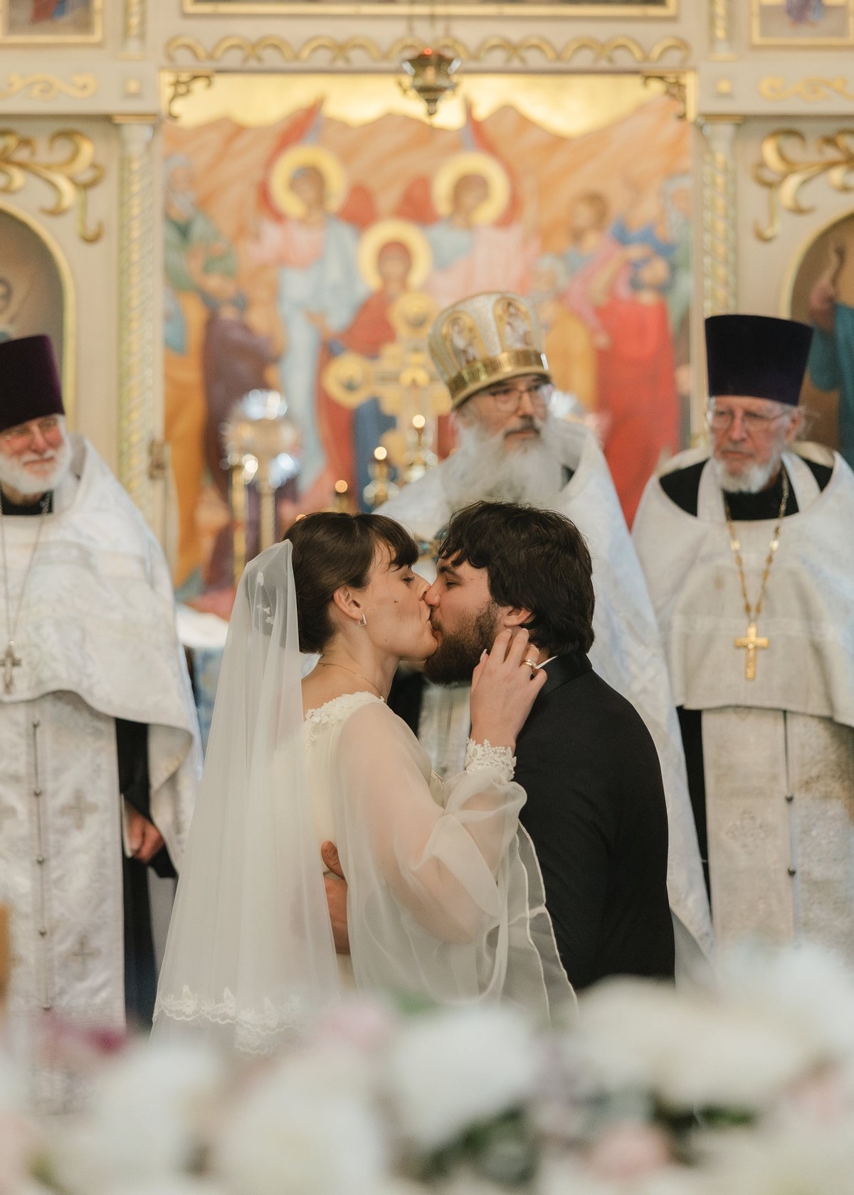 The bride and groom kiss after the wedding ceremony