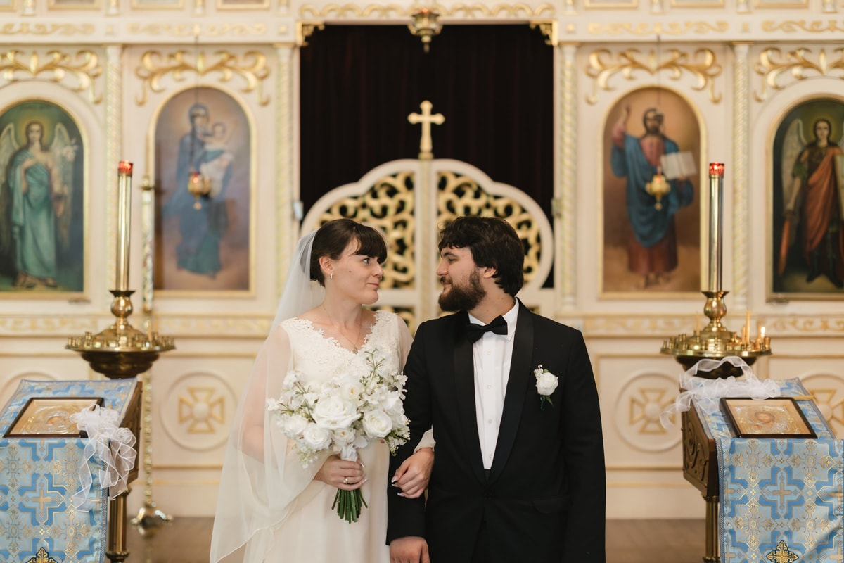 The bride and groom hold icons presented after their wedding