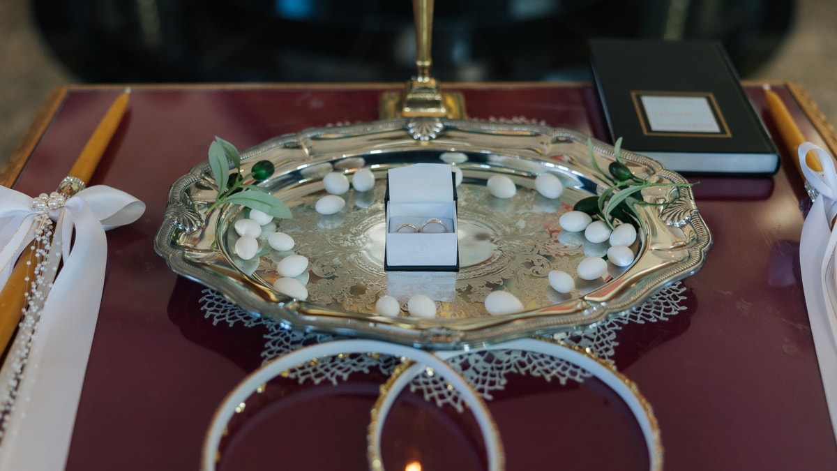 Wedding rings and ribbon arranged on a silver tray