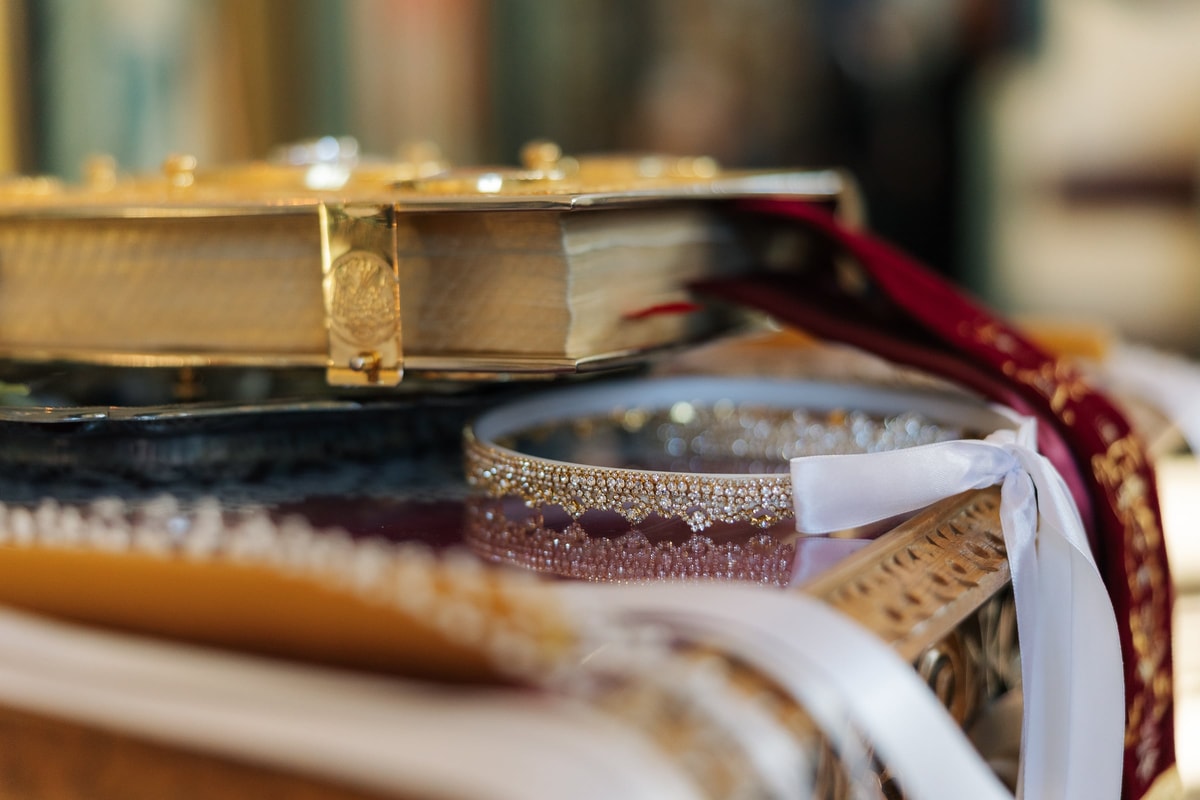 Wedding rings resting beside the Gospel book