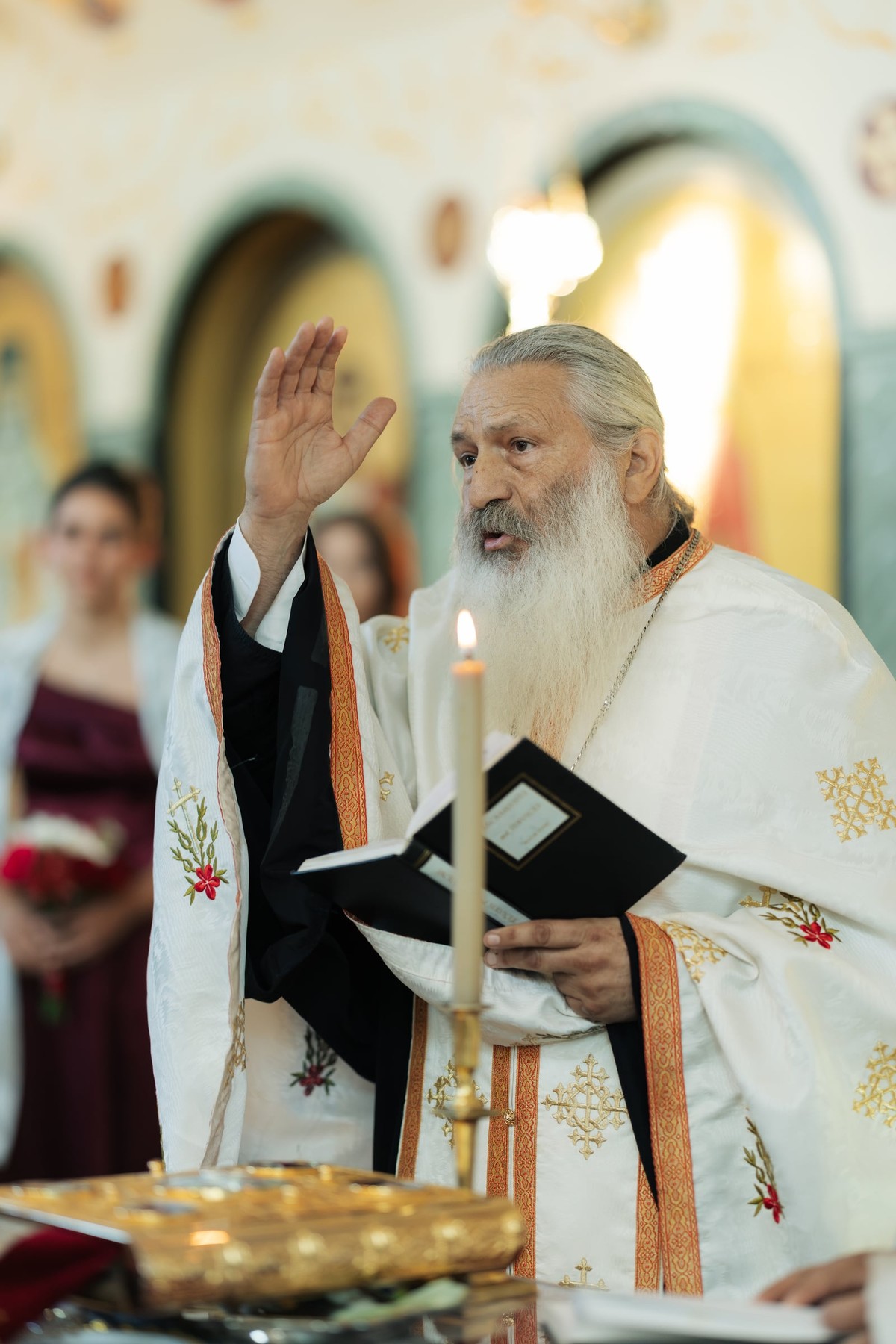 A priest reads from the marriage service