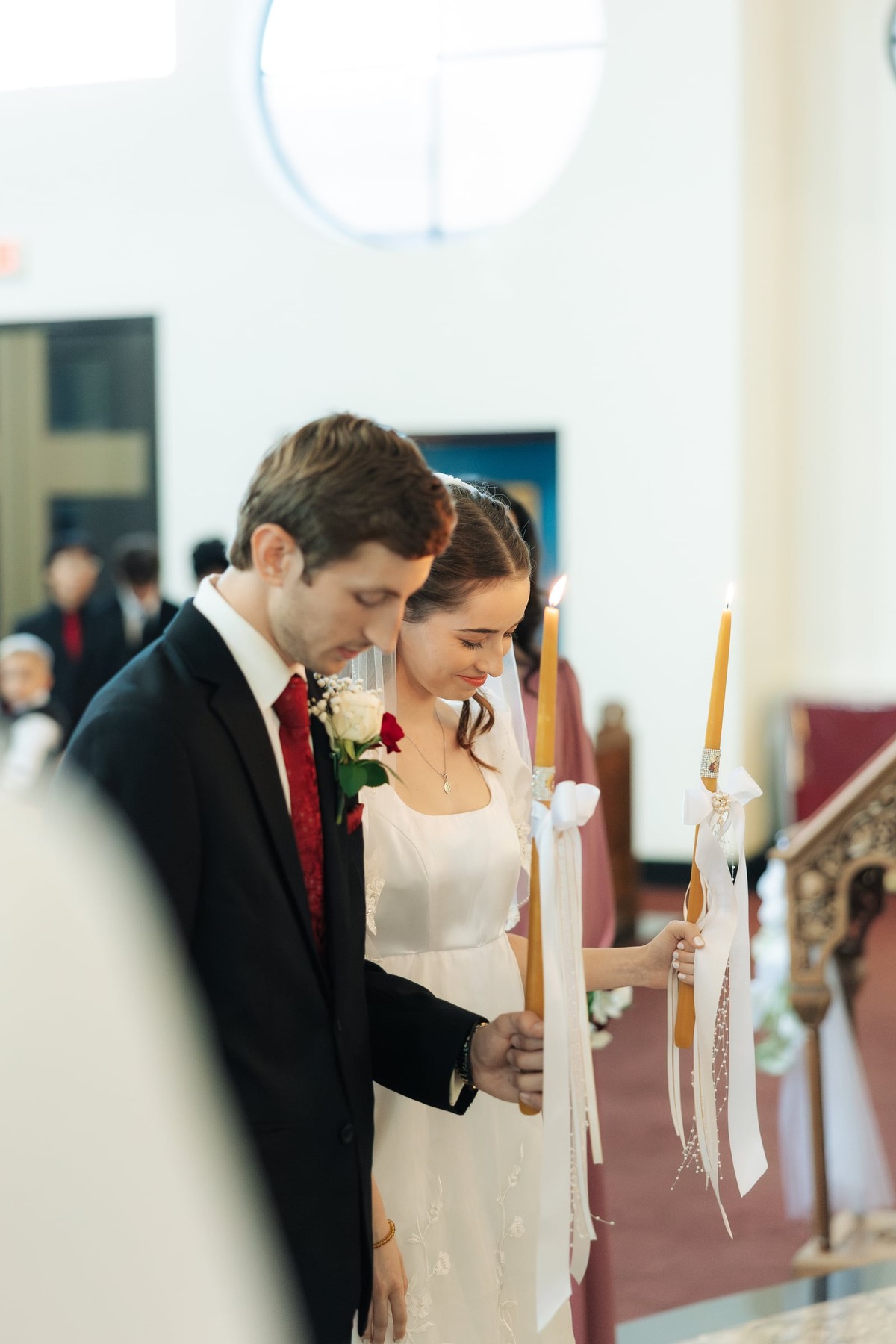 The bride and groom bow their heads during a prayer