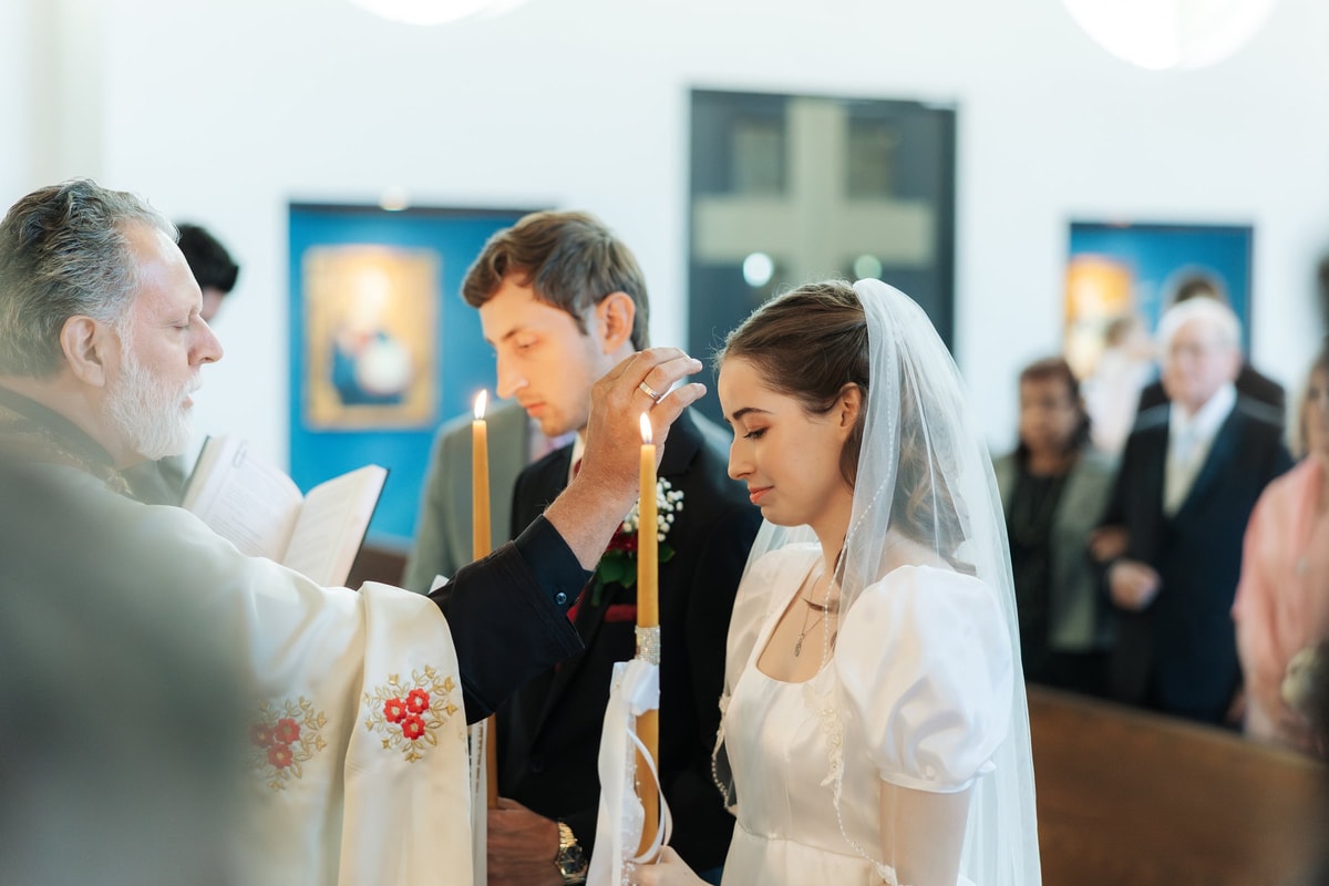 An Orthodox priest blesses the bride during the wedding service