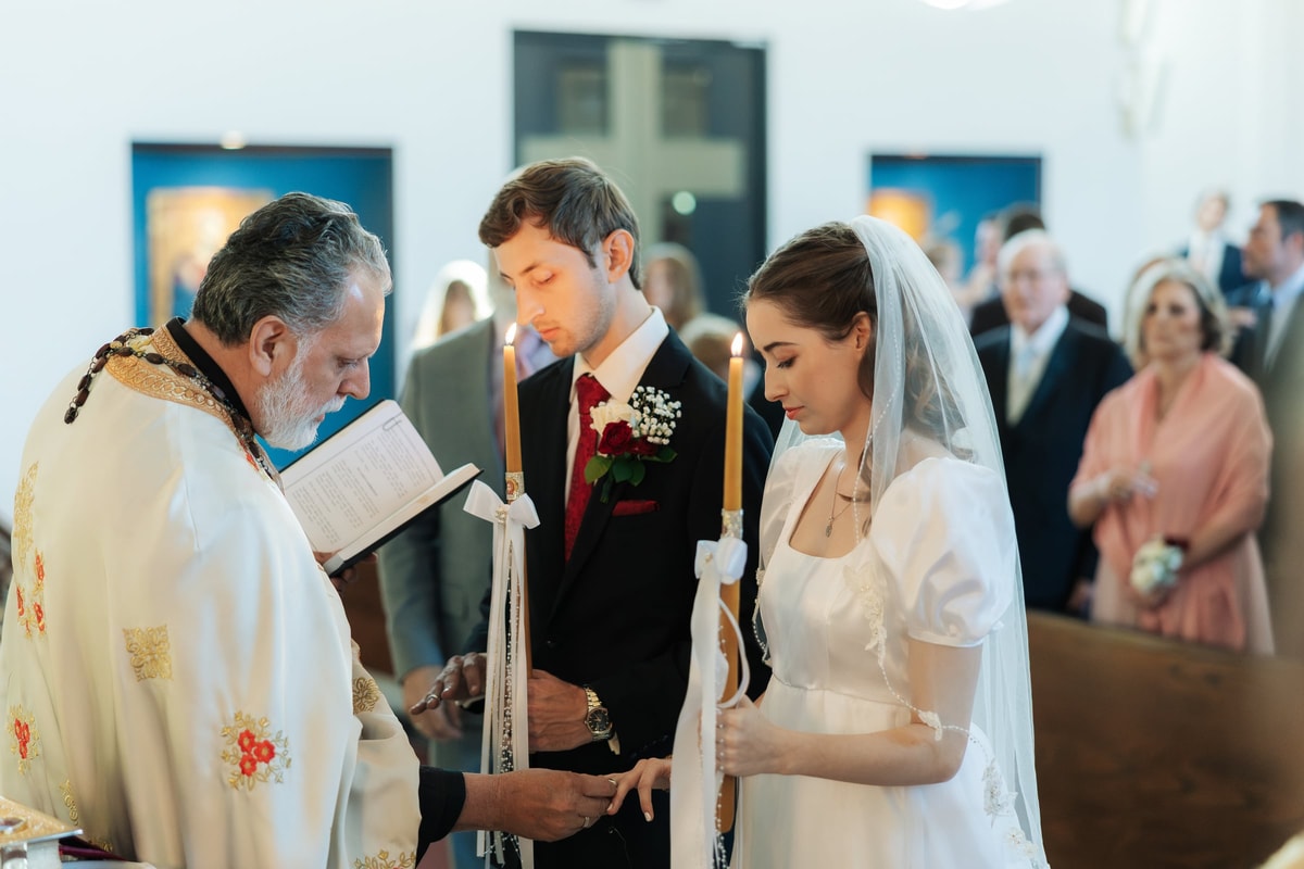 The bride and groom stand together for the blessing of the rings