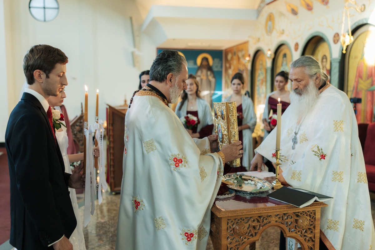 A priest reads prayers at the carved tetrapod