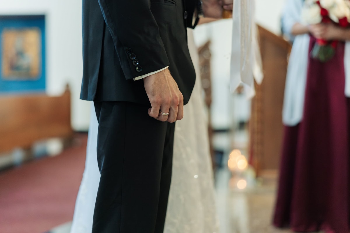 The bride and groom hold hands during the ceremony