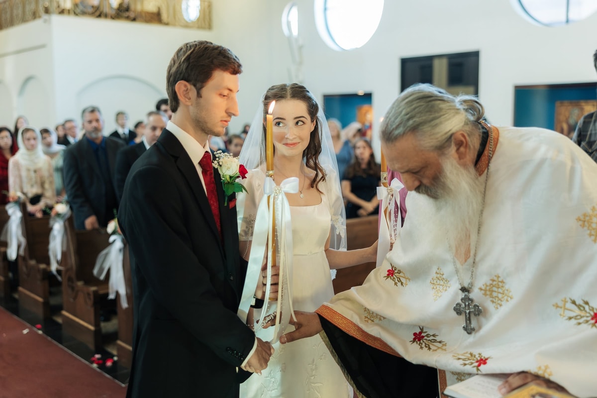 A priest joins the couple's hands