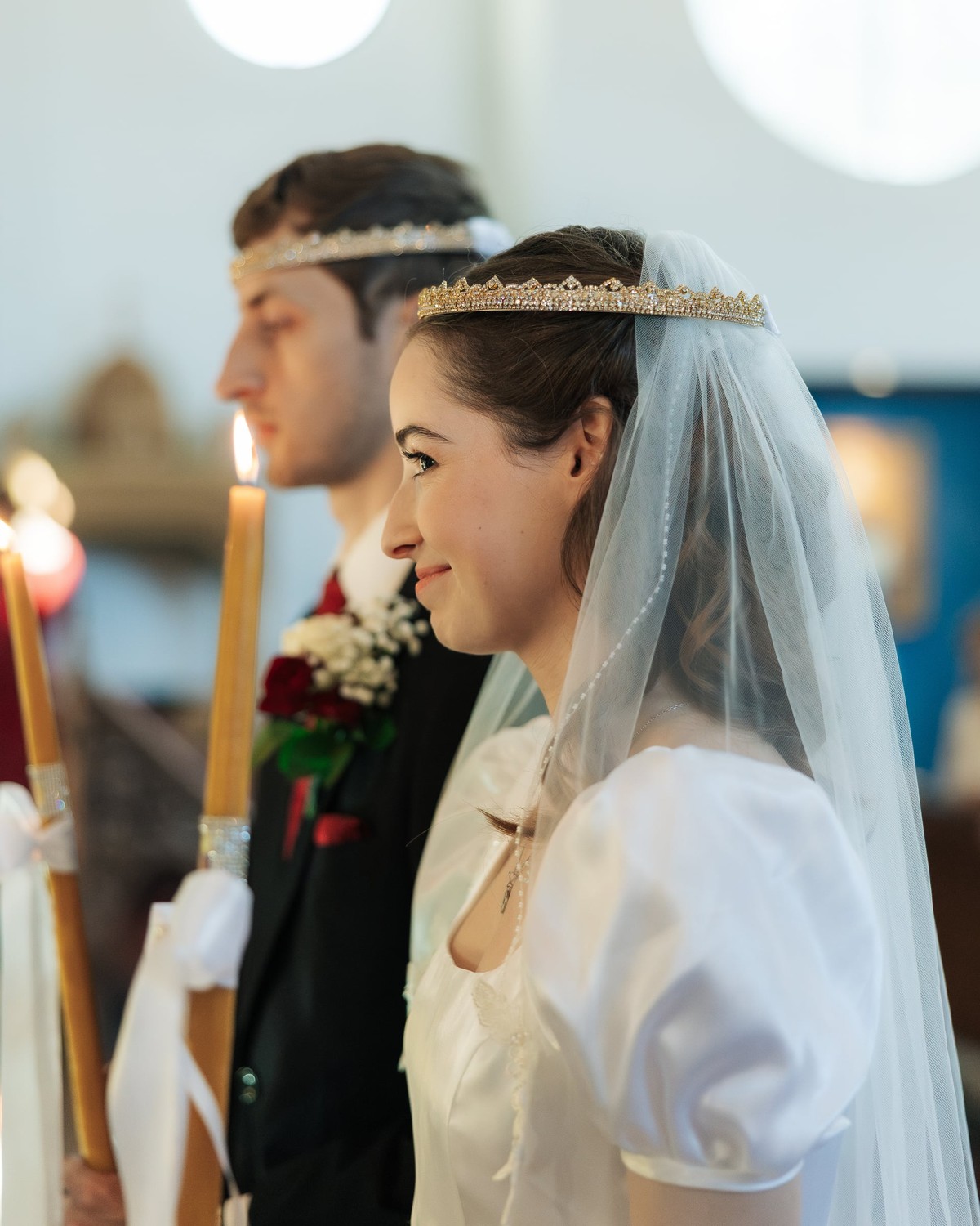 The bride wears her ribboned wedding crown
