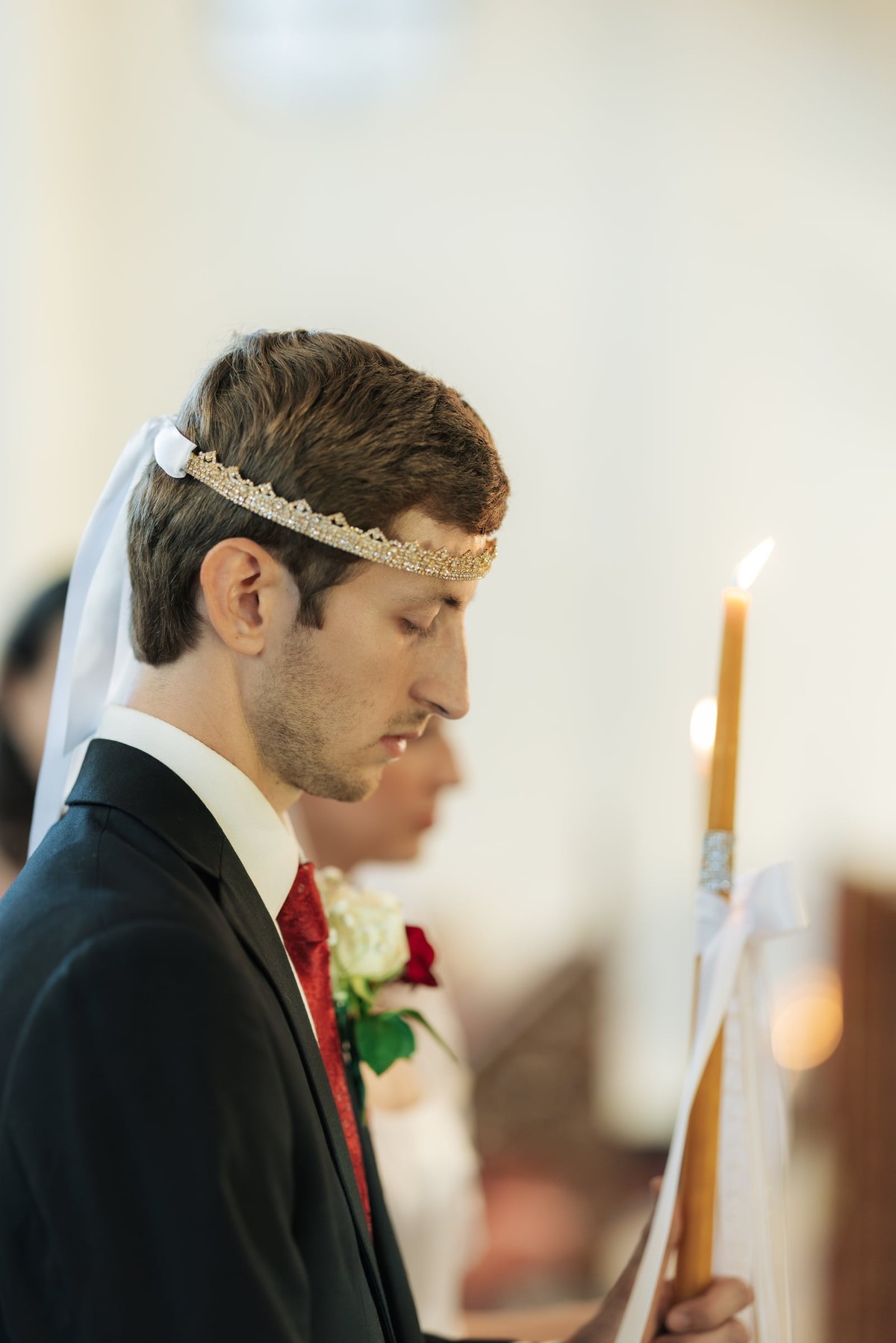 The groom wears his wedding crown during the service