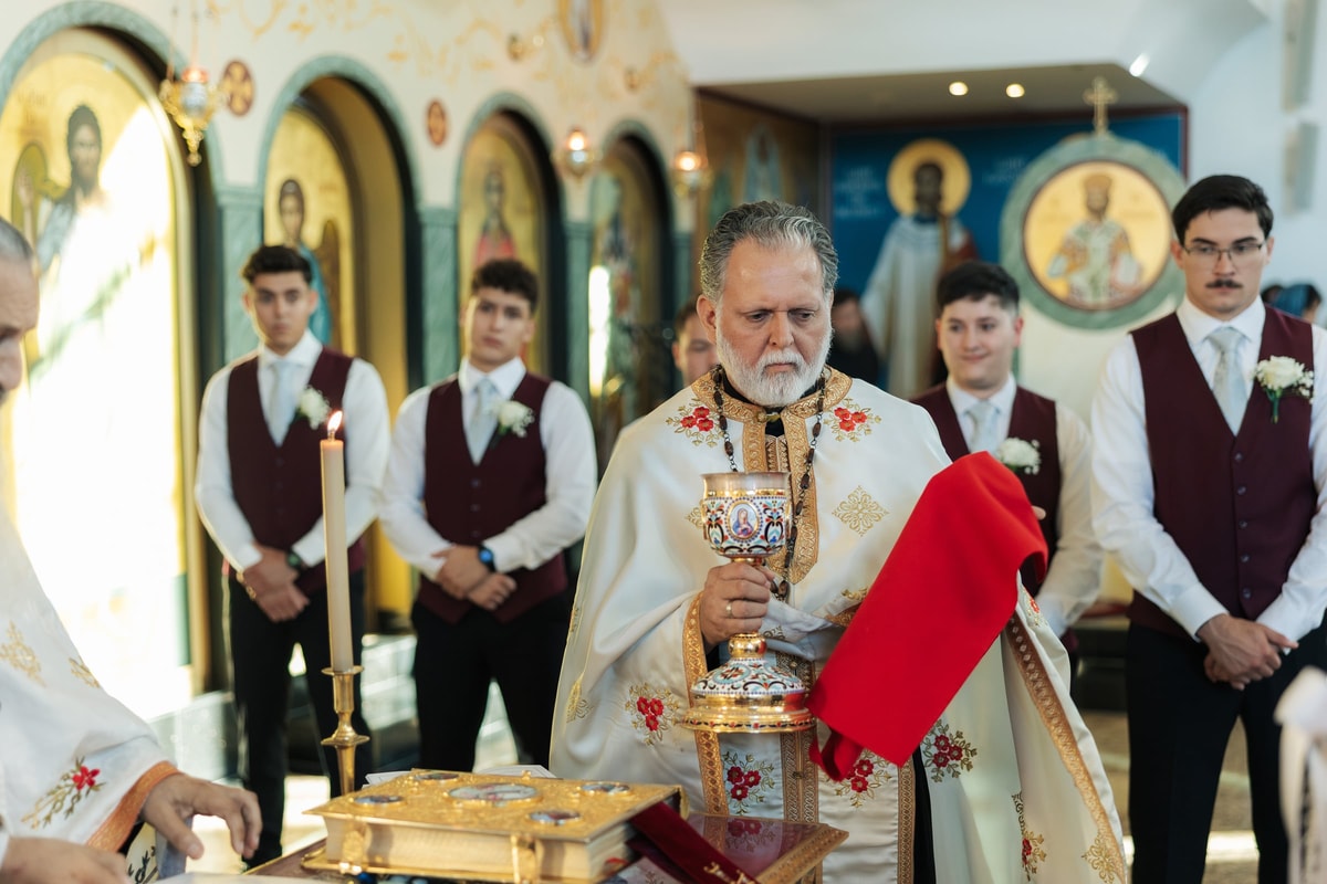 A priest prepares the common cup at the tetrapod